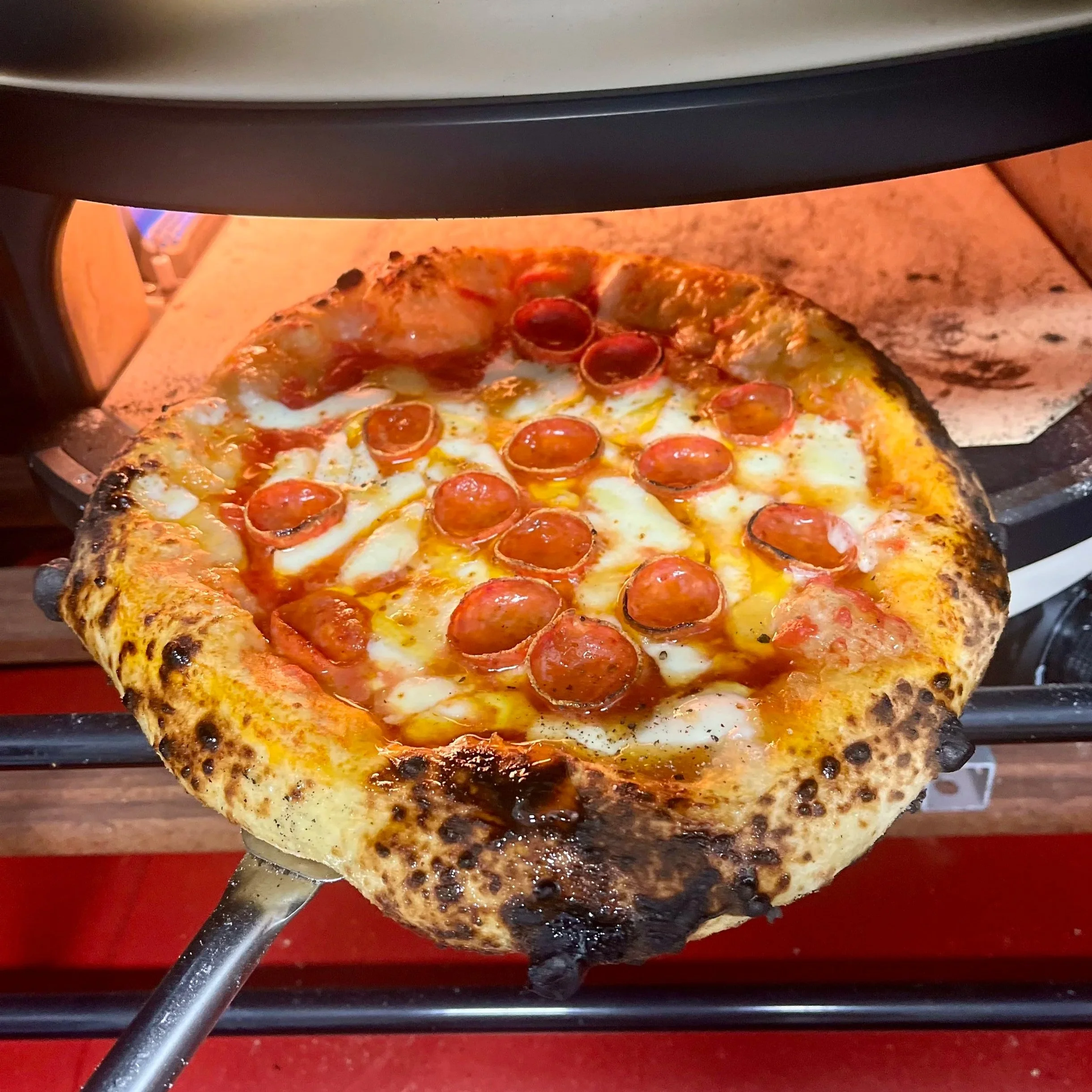 Pepperoni and hot honey pizza served from Soci Pizza truck catering in Raleigh-Durham, NC, fresh from the wood-fired oven.