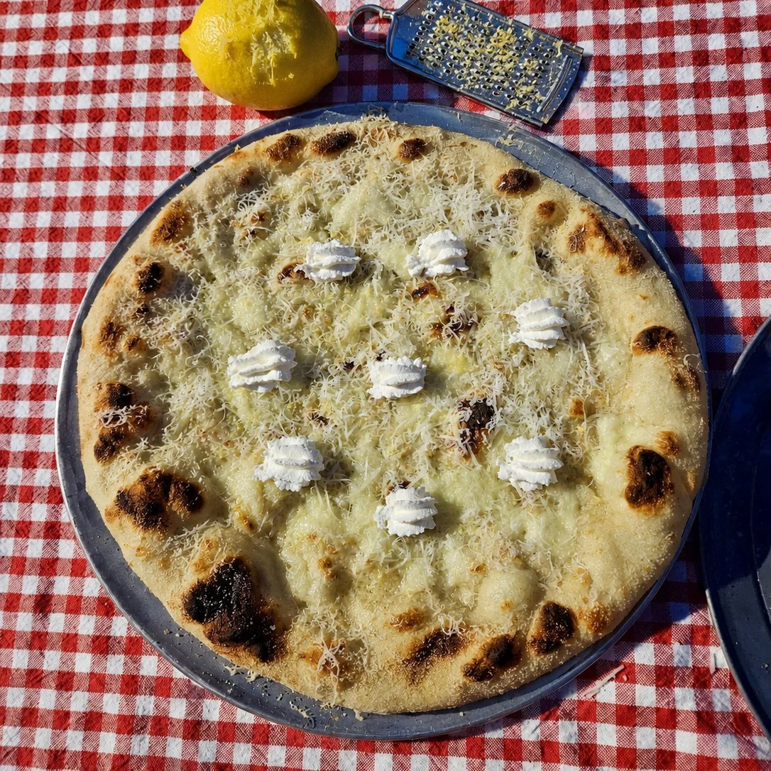 Bianca pizza by Soci pizza with a lemon on the red checkered table in North Carolina.