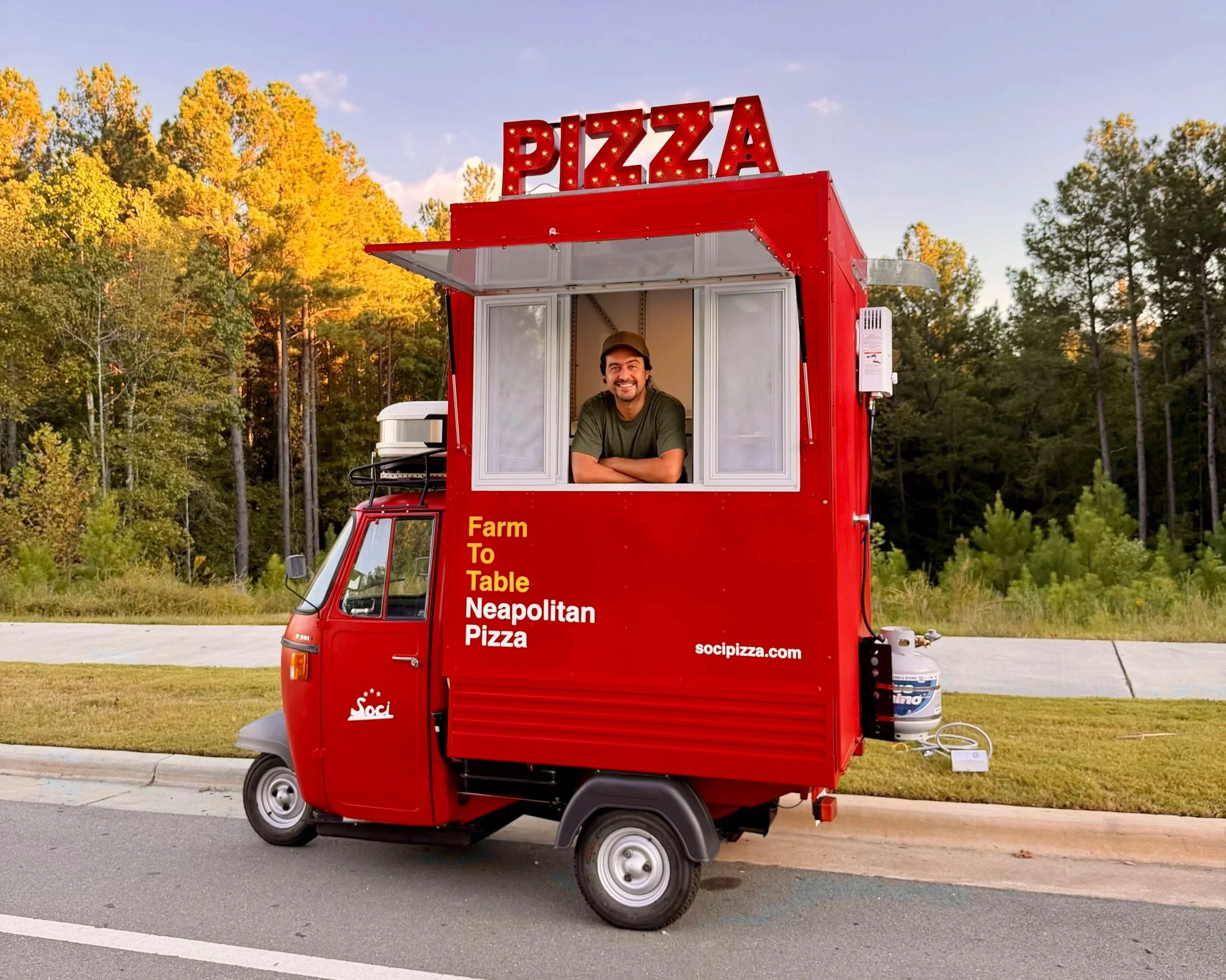 Soci pizza truck providing pizza truck catering on the road in Raleigh-Durham, North Carolina, surrounded by green trees, for weddings, parties, and corporate events.