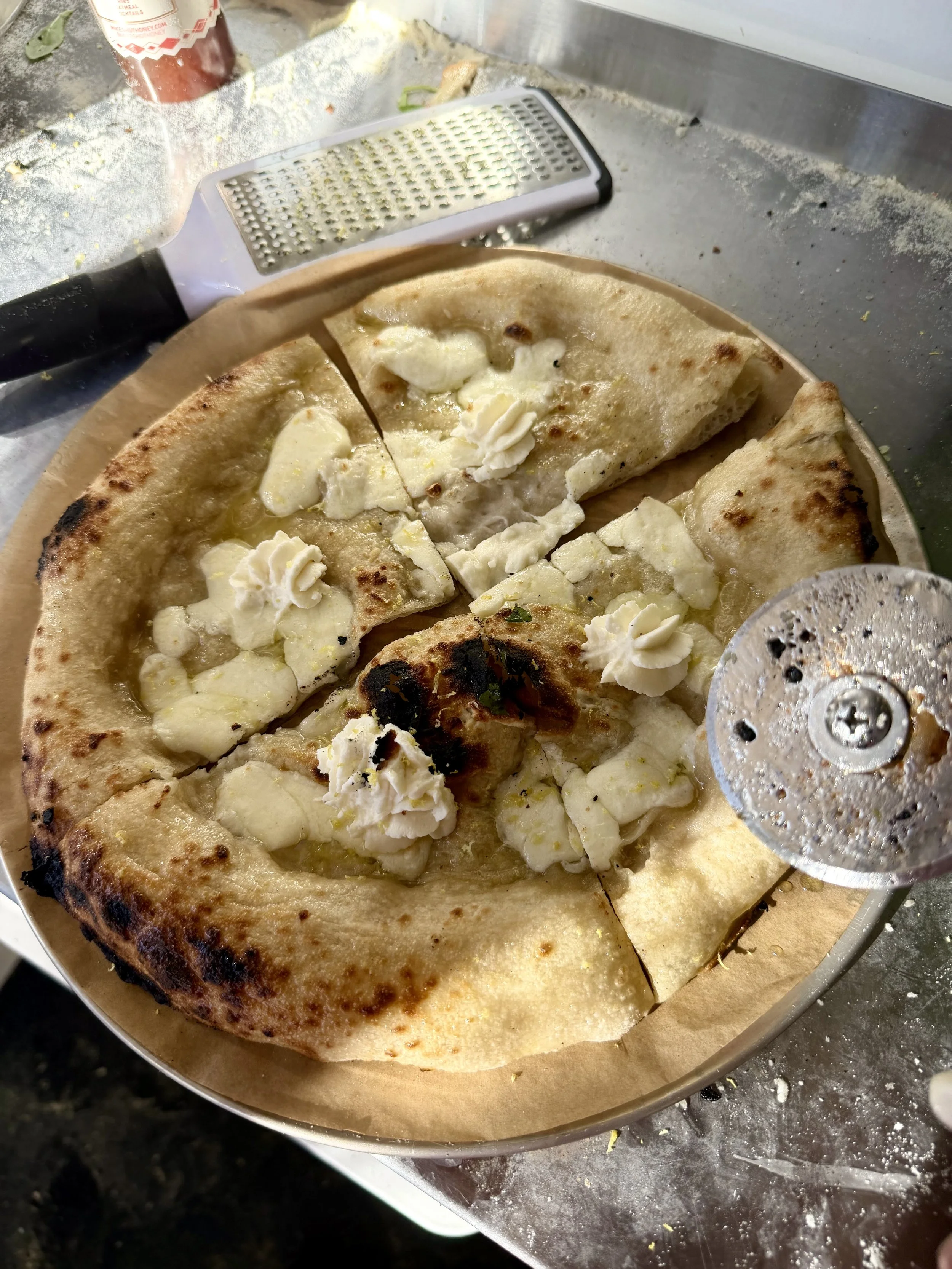 Bianca pizza served from Soci Pizza truck catering in Raleigh-Durham, NC, with fresh mozzarella, ricotta, and gourmet seasonings.