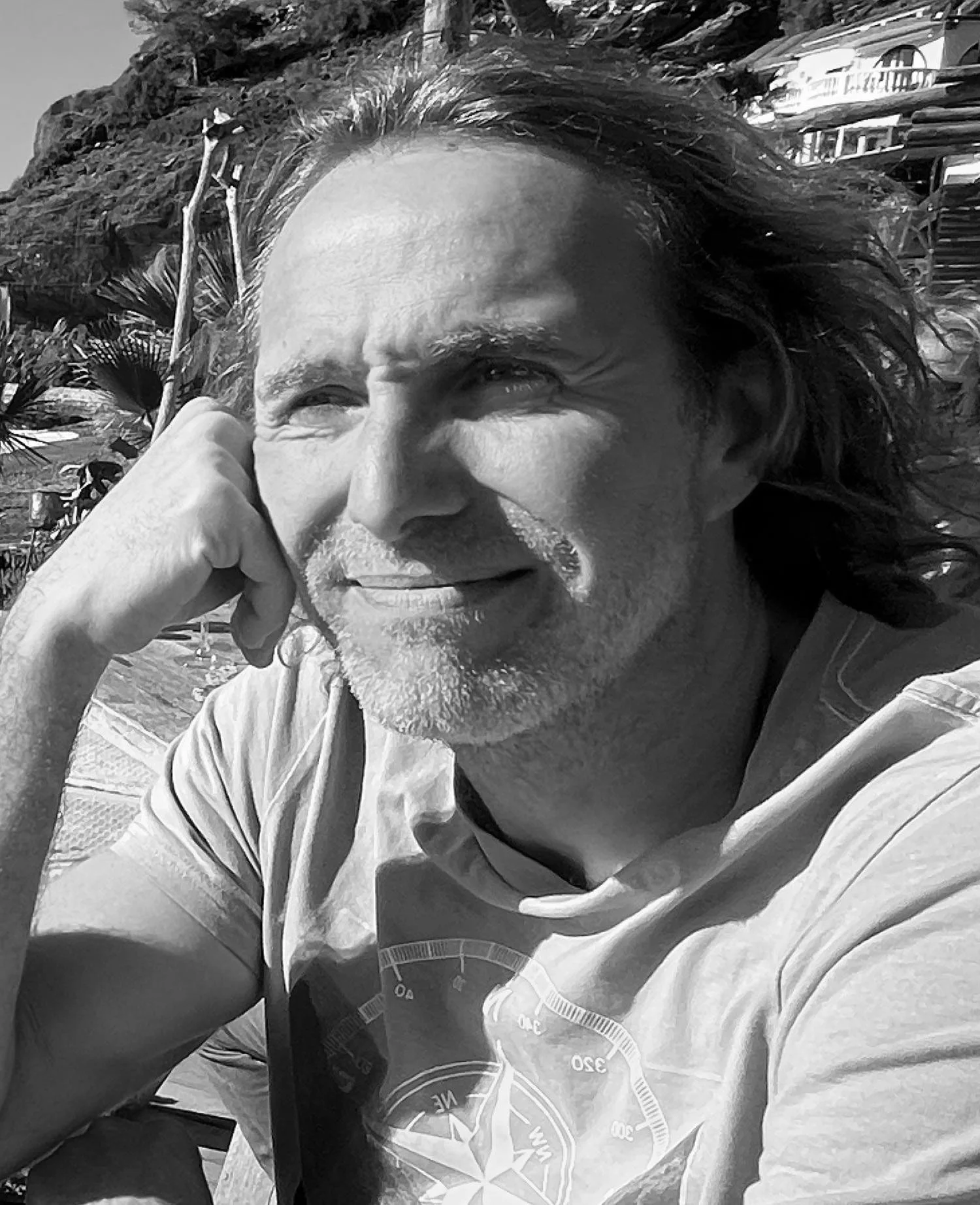 Fernando Gomez on a beach looking peacefully out into the distance.