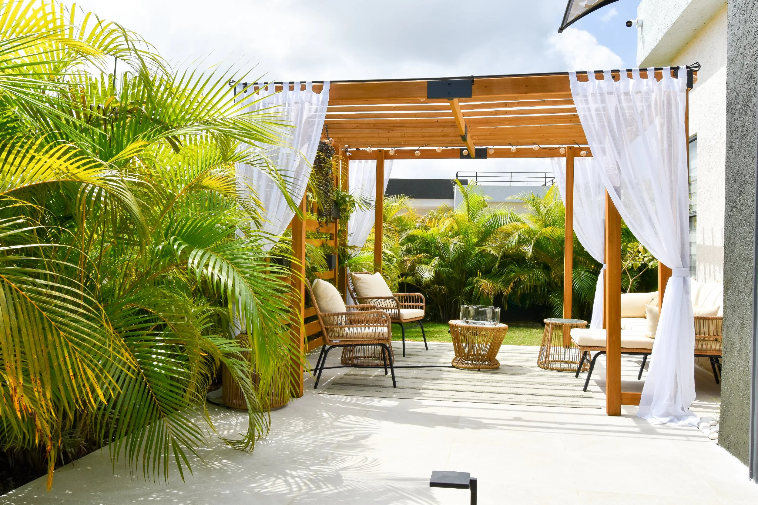 Modern pergola and tropical outdoor living space designed in Jamaica — AurumScape landscape design.