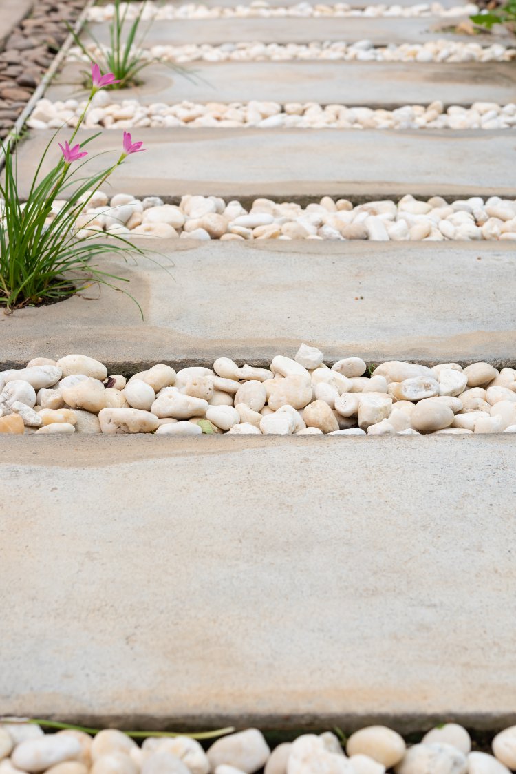 Natural stone garden stepping path with decorative gravel joints and integrated planting