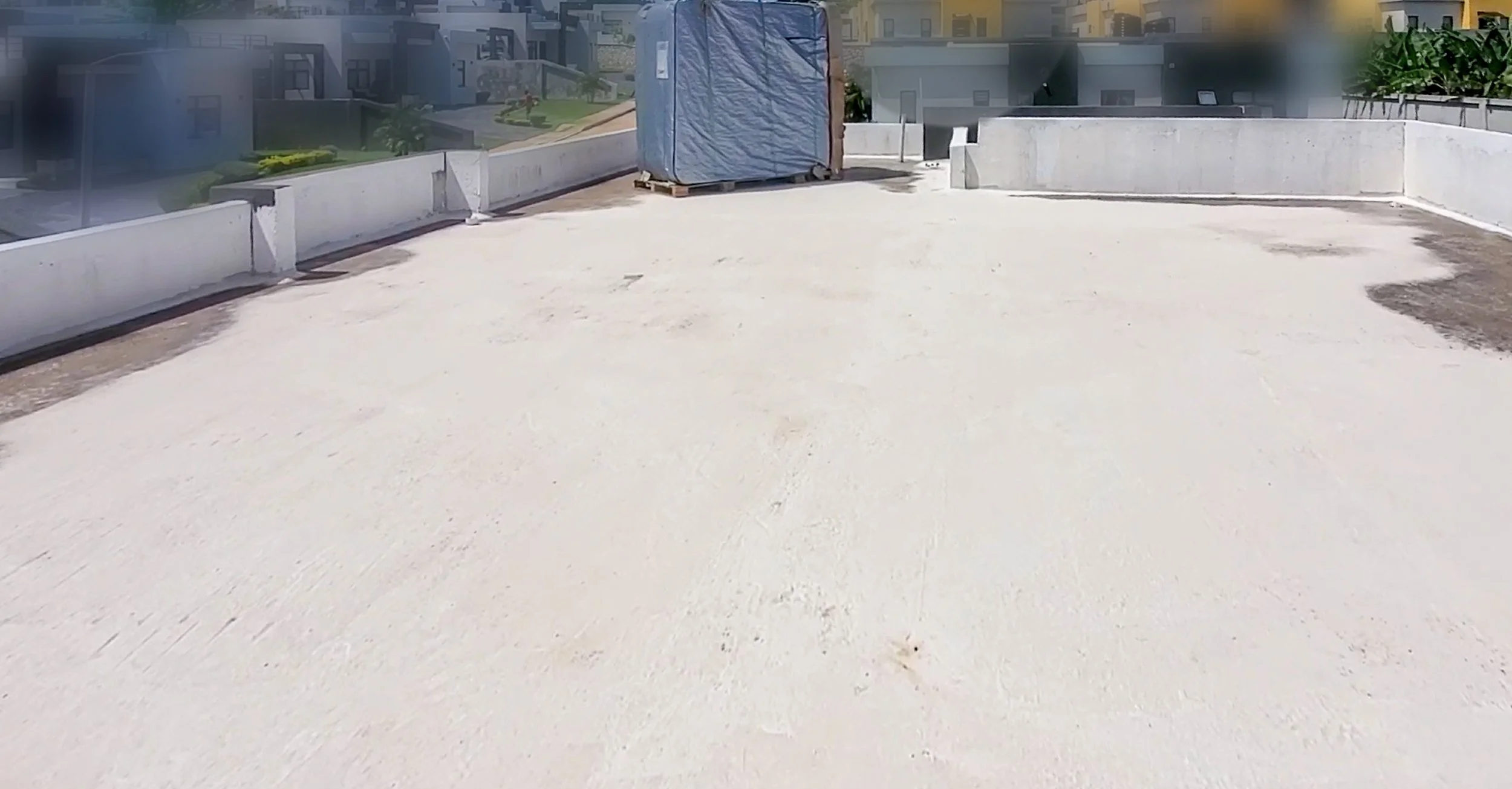 Empty rooftop before landscaping and design installation – bare concrete surface prepared for transformation into modern rooftop garden terrace in Jamaica.