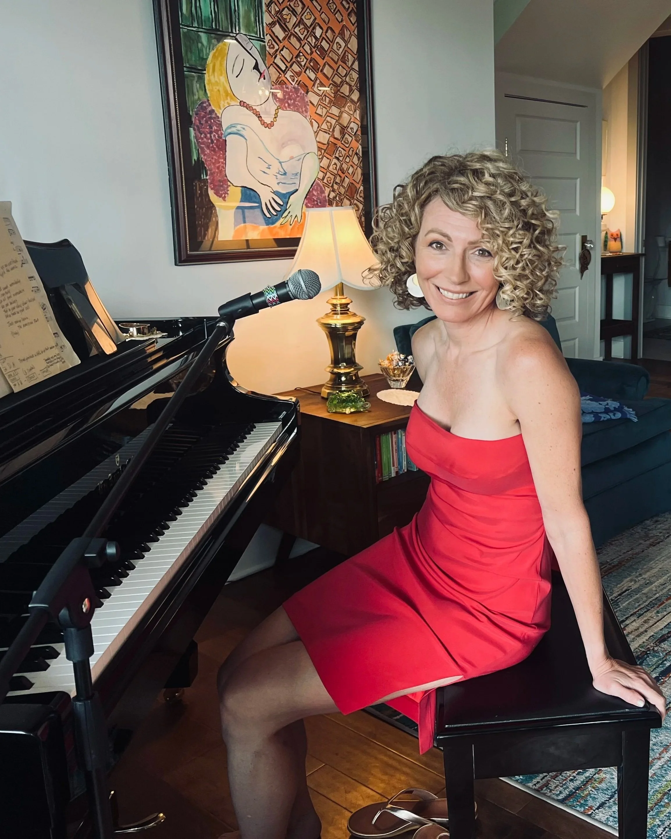 Leora Nosko sitting at her baby grand piano preparing for a house concert with Alex Wright of Louisville, Kentucky.