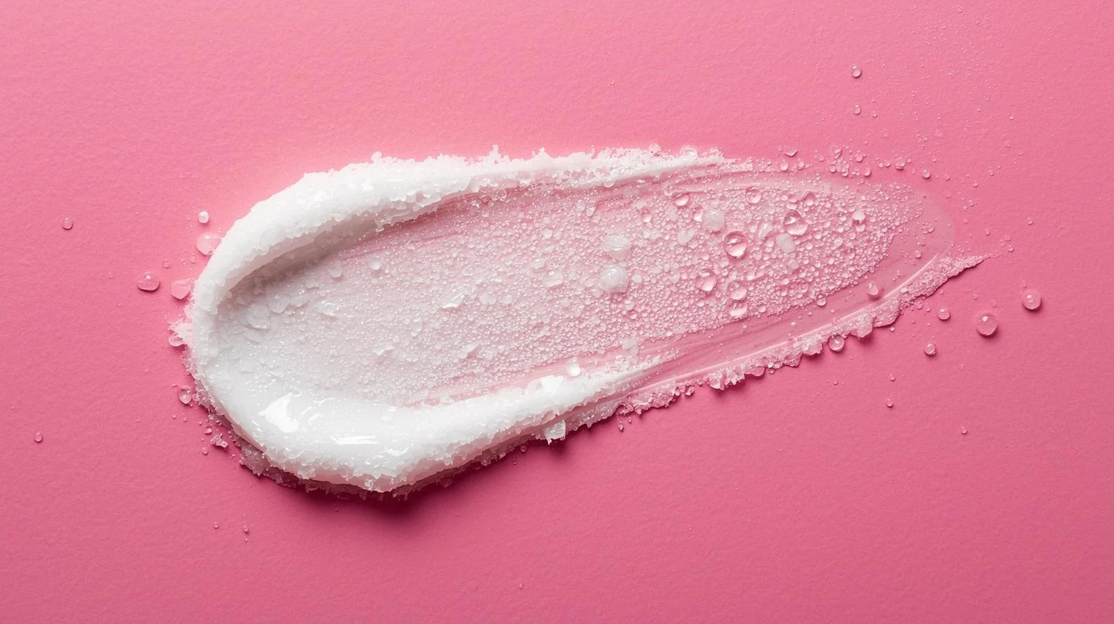 white sugar scrub smeared pink background wet.jpg