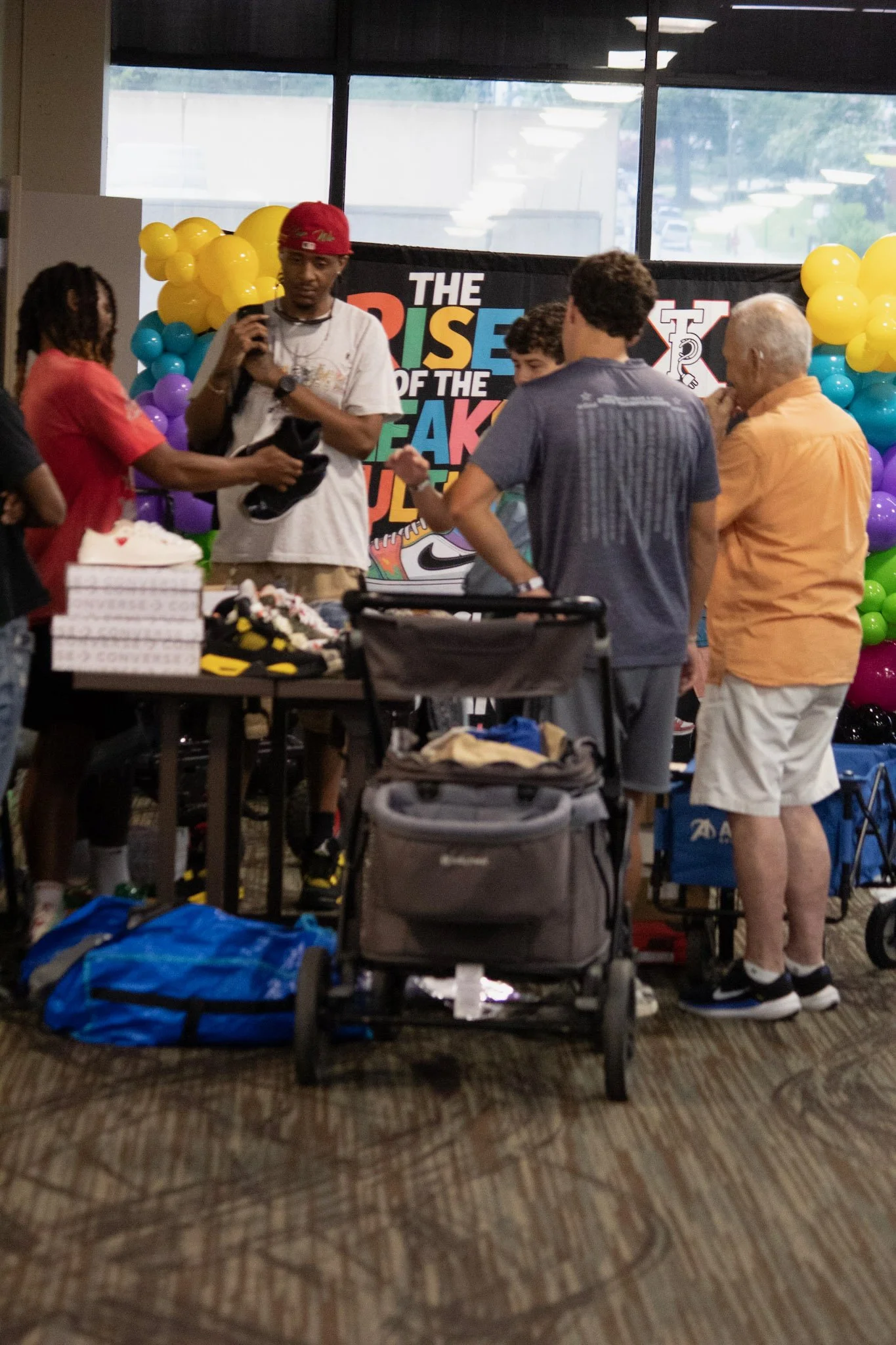 Group of people at a birthday party with balloons and a backdrop that reads 'The Rise of the Break Soul.'
