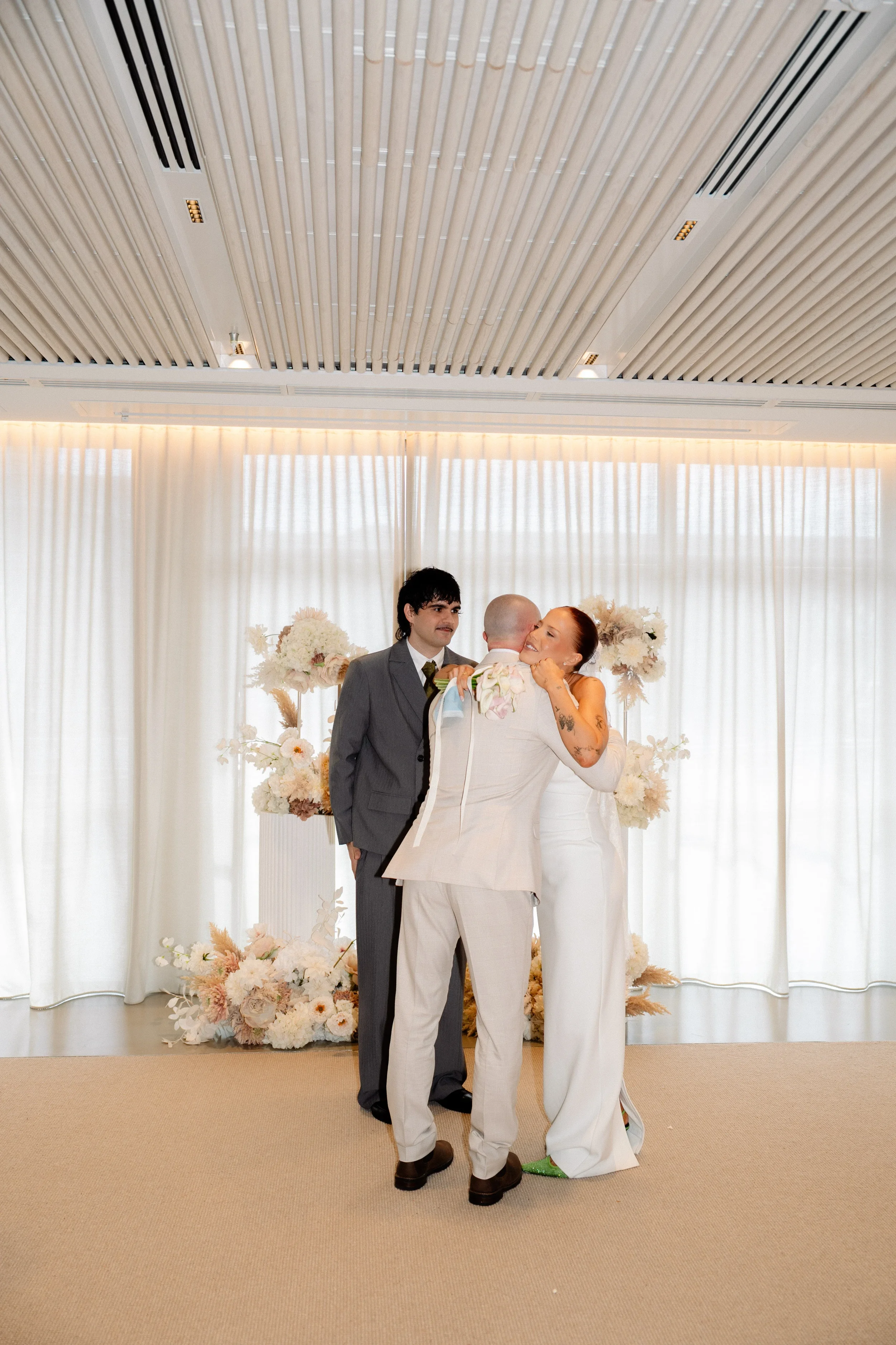 Bride embracing a family member during the wedding ceremony