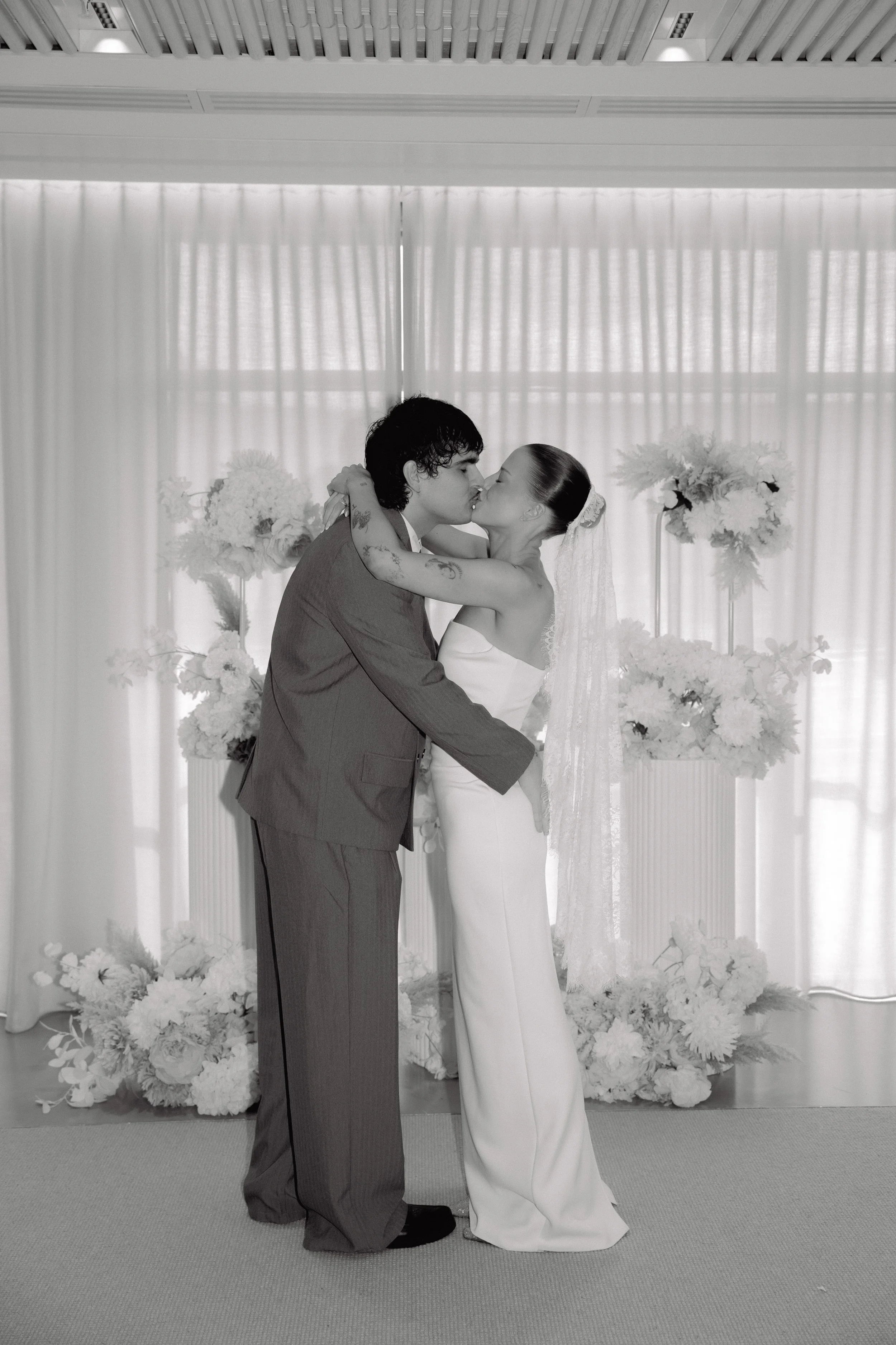 Couple sharing a kiss during the wedding ceremony