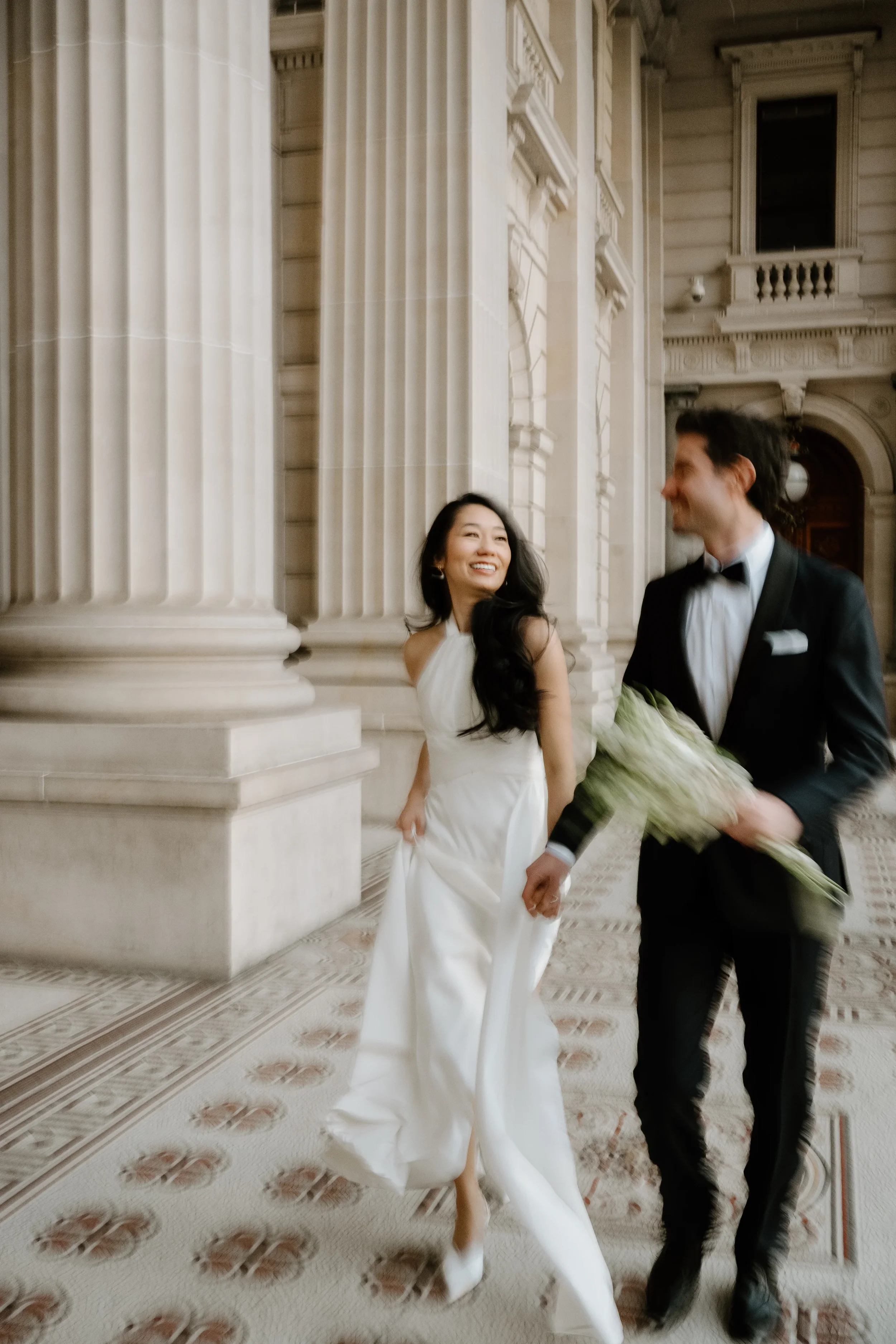 Nadia and Diego walking through Windsor Hotel during elegant Melbourne pre-wedding session