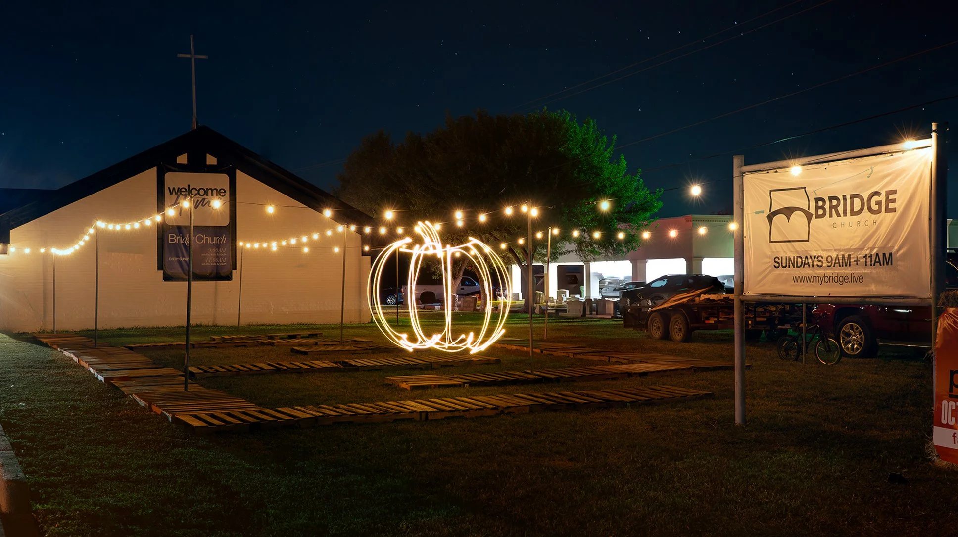 String of warm-colored string lights hanging against a dark background.