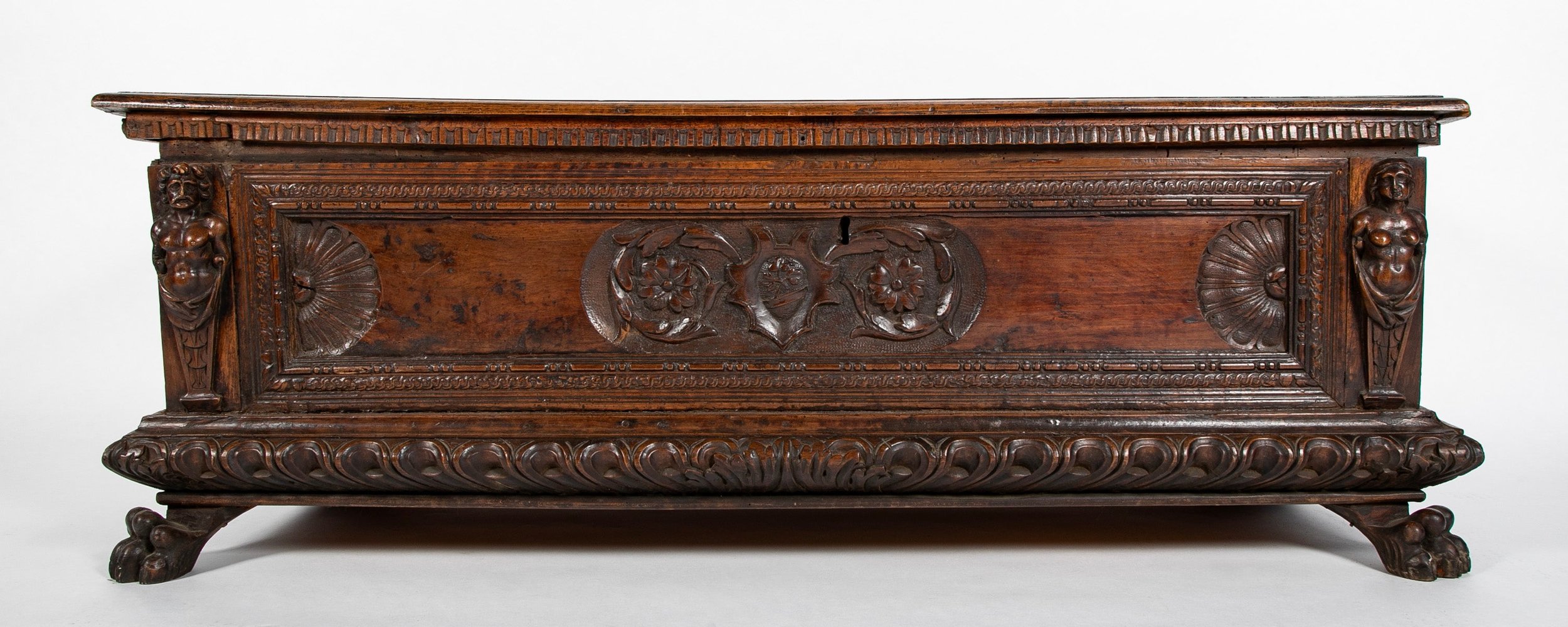 A 16th Century Italian Dark Walnut Cassone (wedding chest) having two carved paw front feet, Adam and Eve carvings, and original handles.  Circa 1590.    