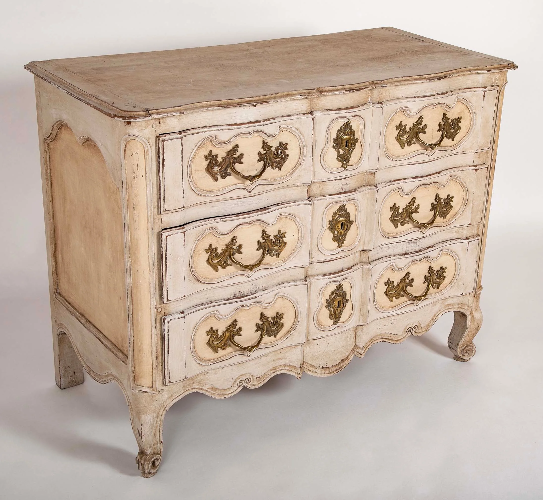 An 18th century robust French provincial Serpentine front commode having three deep drawers and cabriole feet. Circa 1760.  38" h x 48.5"w x 23.5" d