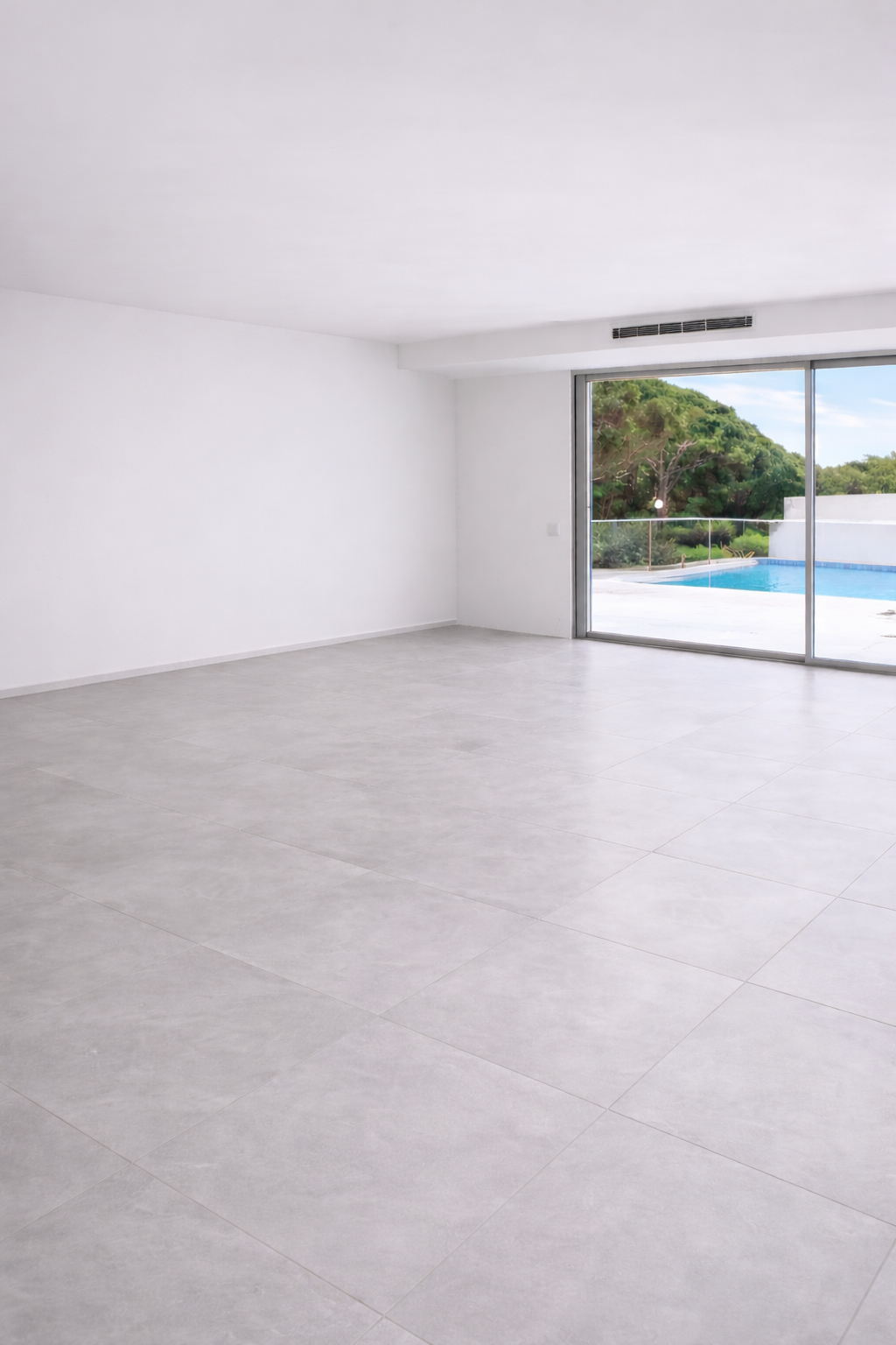 Modern white house with large glass sliding doors, a swimming pool, and a balcony with glass railings under a clear blue sky.