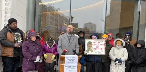 Adam Bojak speaking outside 250 Delaware.