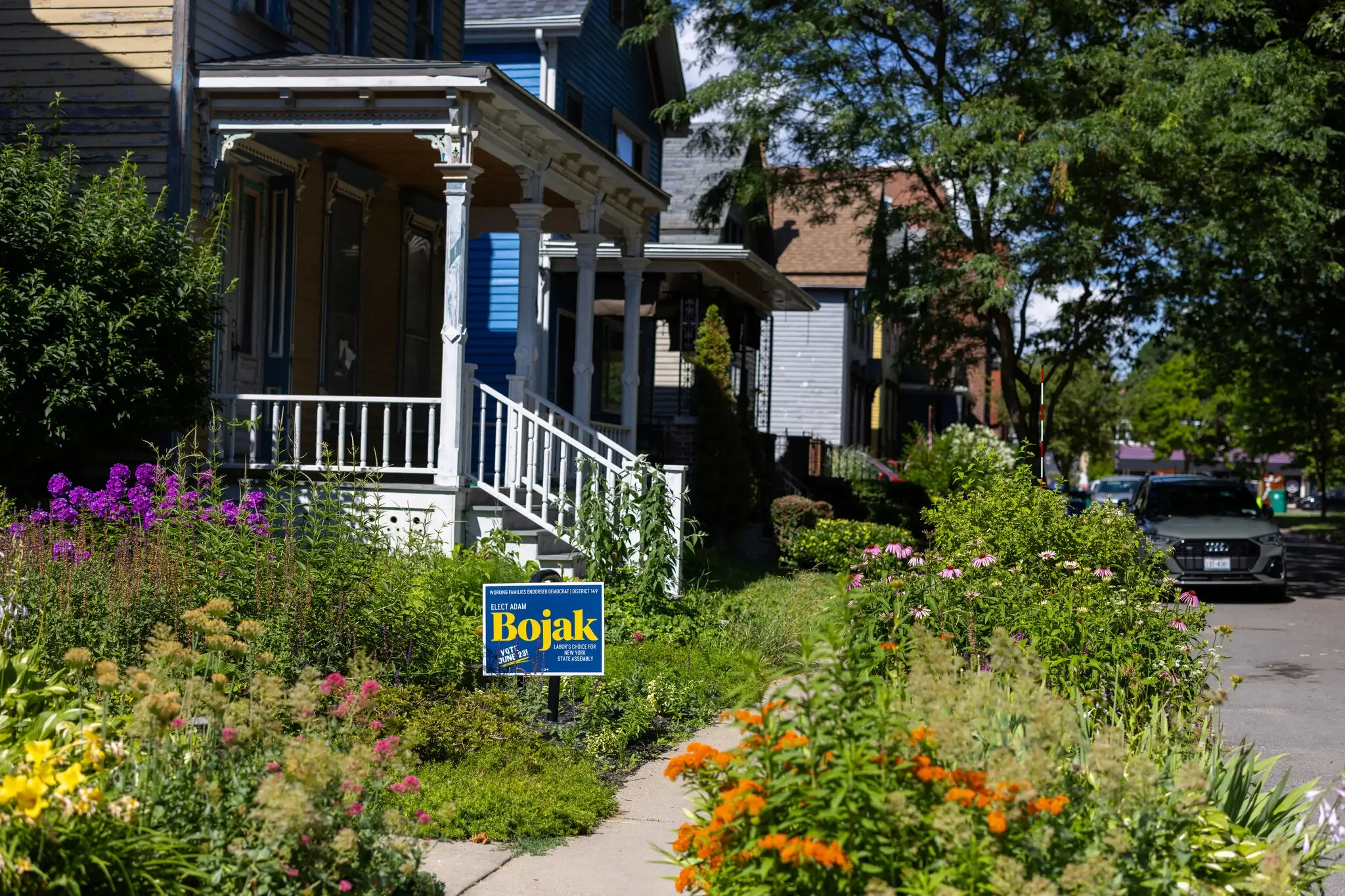 An image of a Bojak for Assembly sign on a floral, bright lawn (Lauren Petracca, NYT)