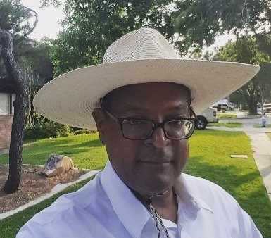 photo of Alfred Molison with straw hat and spectacles