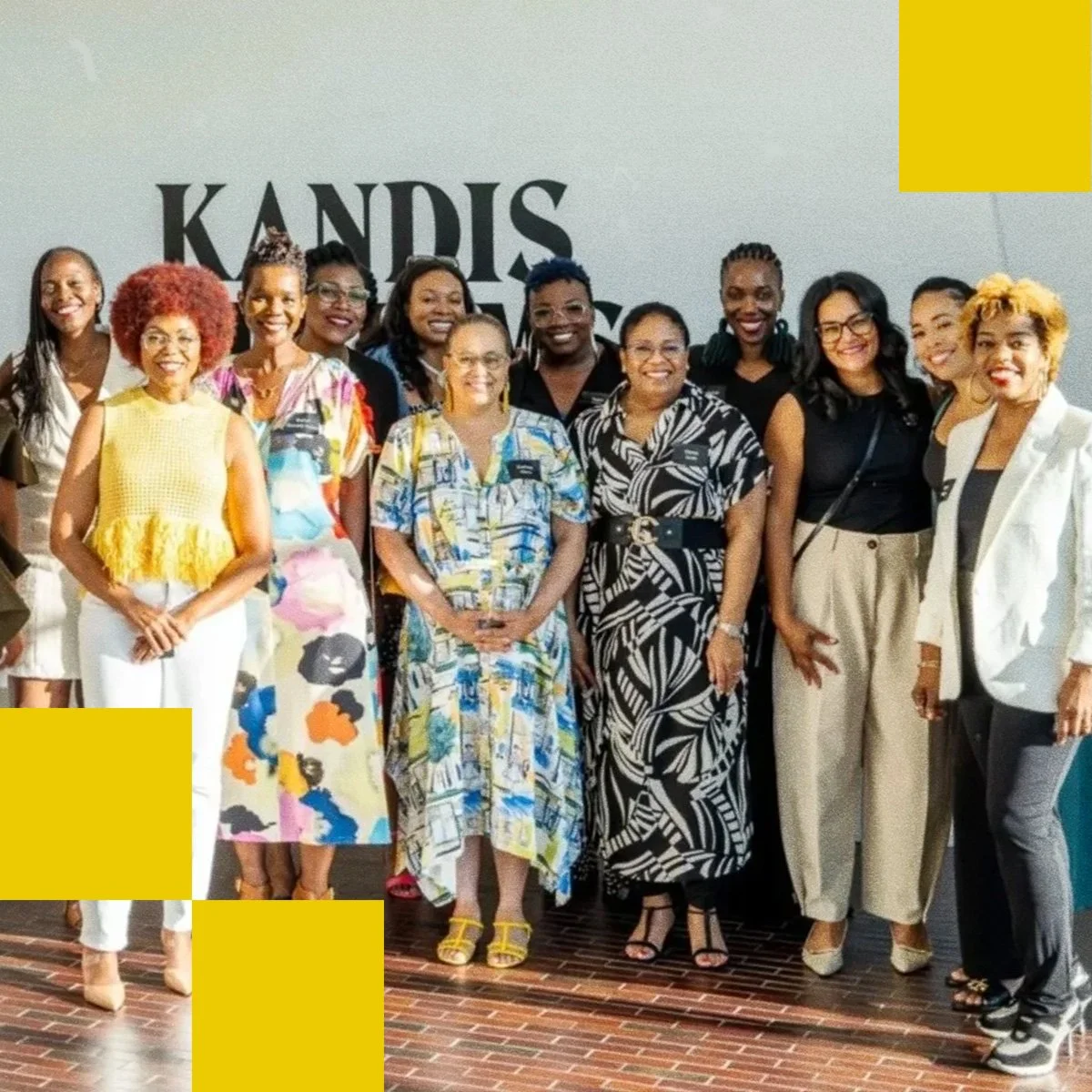A group of well-dressed women standing next to Seena Hodges and smiling