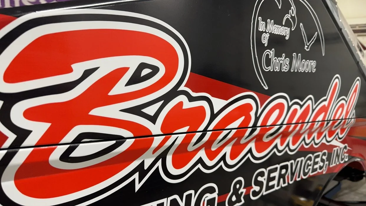 Vehicle wrap with the logo 'Brad's' and text memorial for 'Chris Moore', indicating a memorial service for Chris Moore.