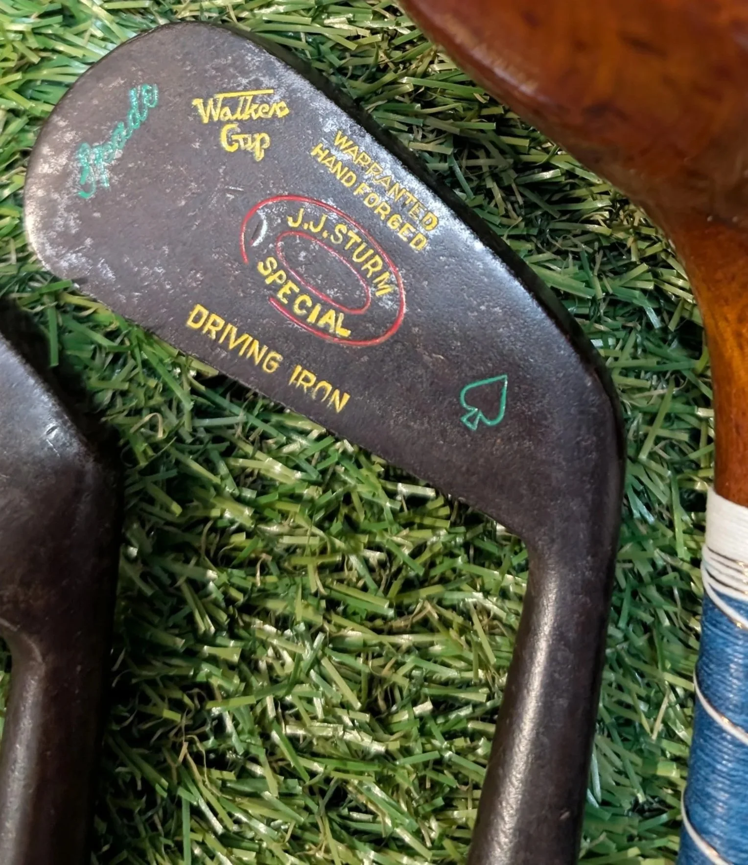 A restored hickory golf club with color painted accents.
