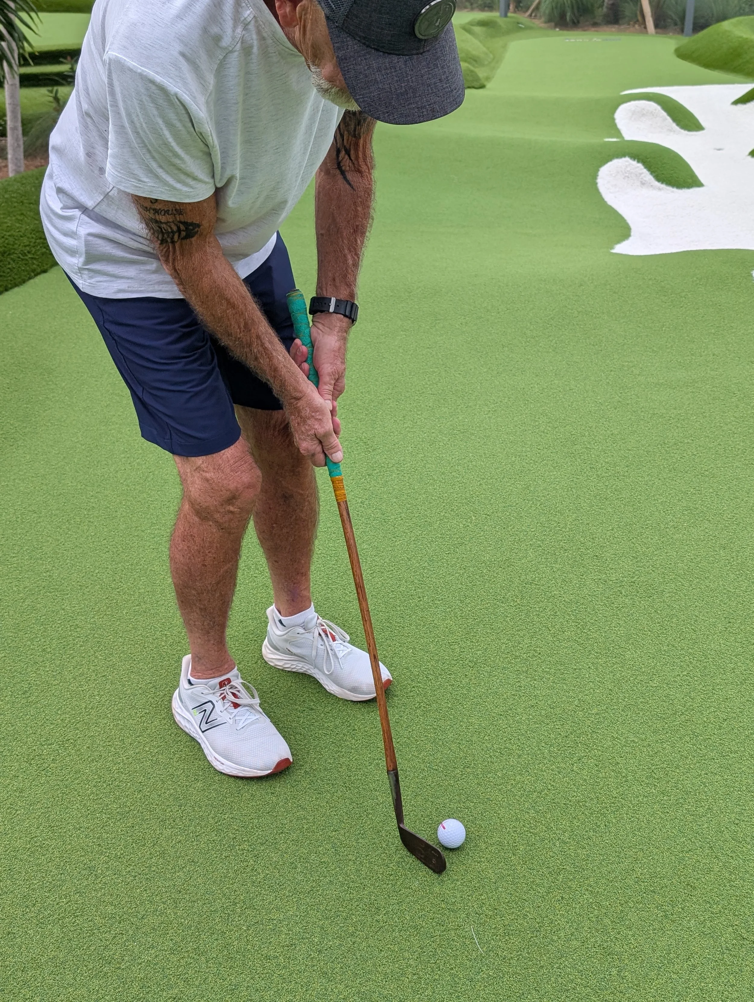 A golfer playing with a Groundhog Hickory Golf hickory golf club