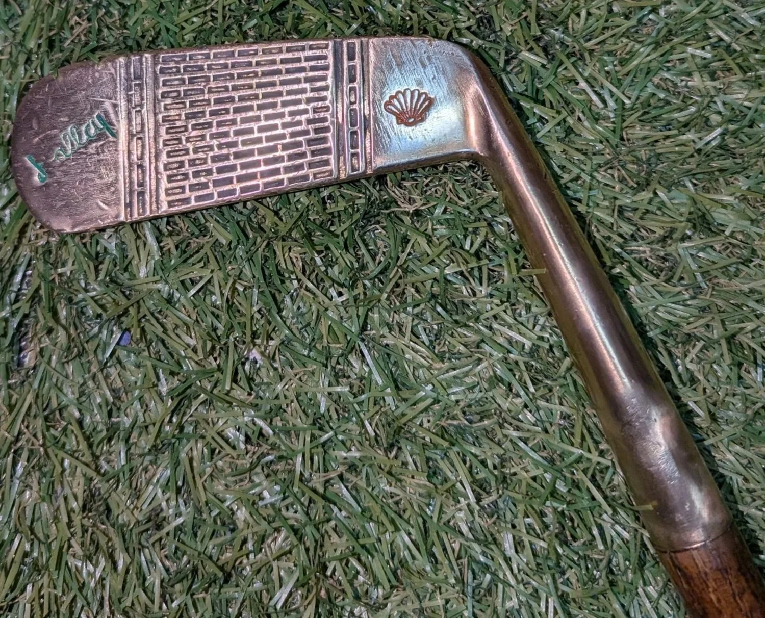 Ambidextrous hickory golf club putter with a brass head and Miami Hurricanes colors