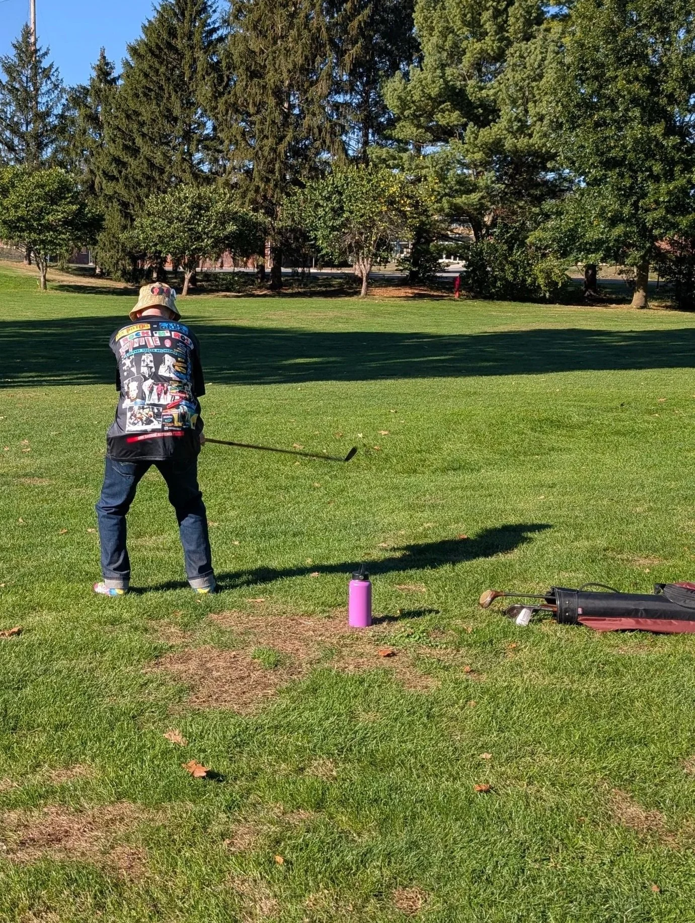 A golfer playing with a Groundhog Hickory Golf hickory golf club