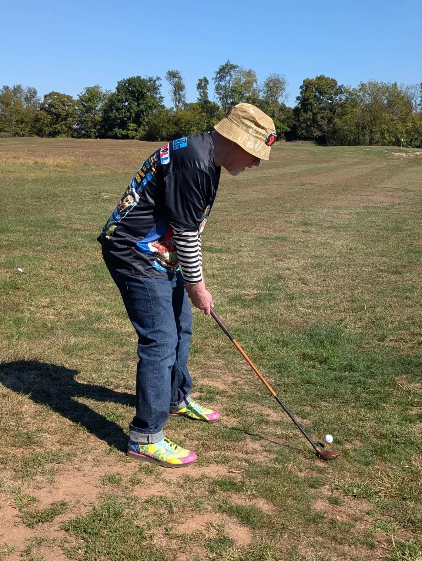A golfer playing with a Groundhog Hickory Golf hickory golf club