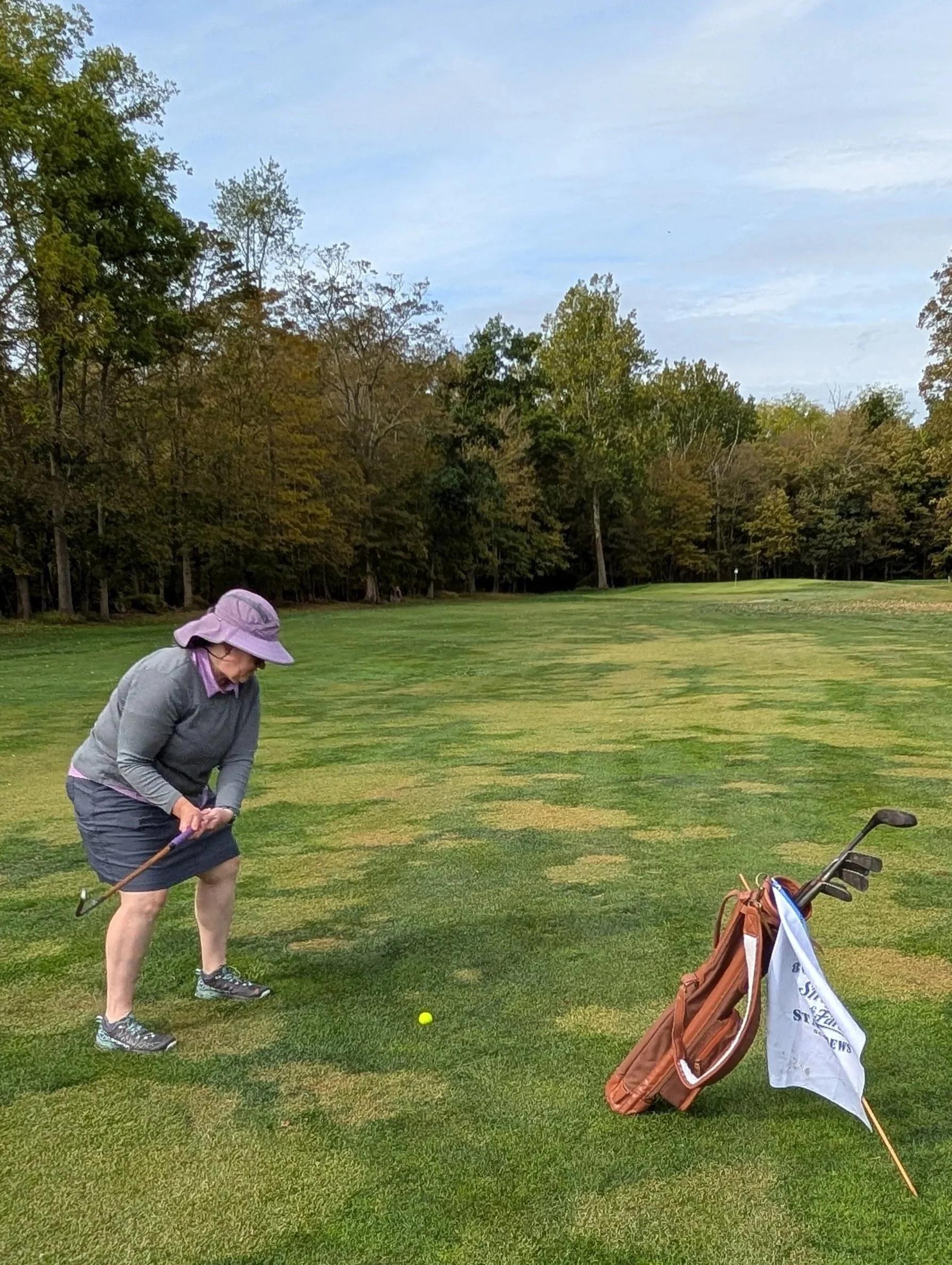 A golfer playing with a Groundhog Hickory Golf hickory golf club