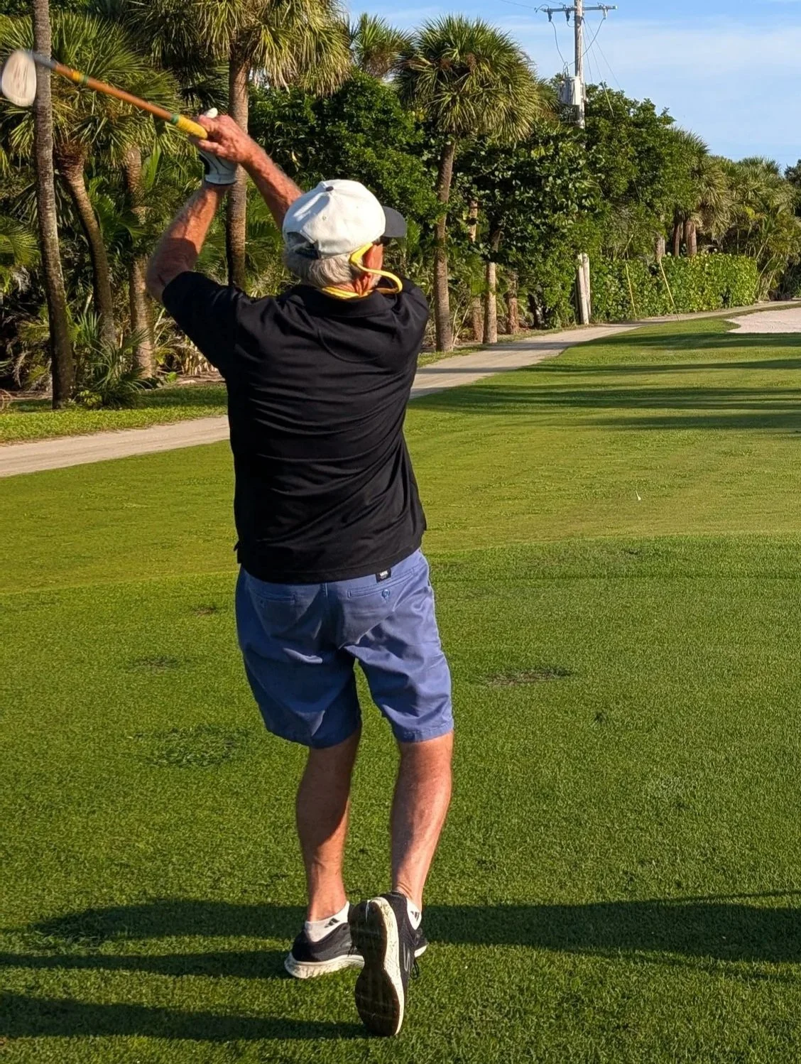 A golfer playing with a Groundhog Hickory Golf hickory golf club