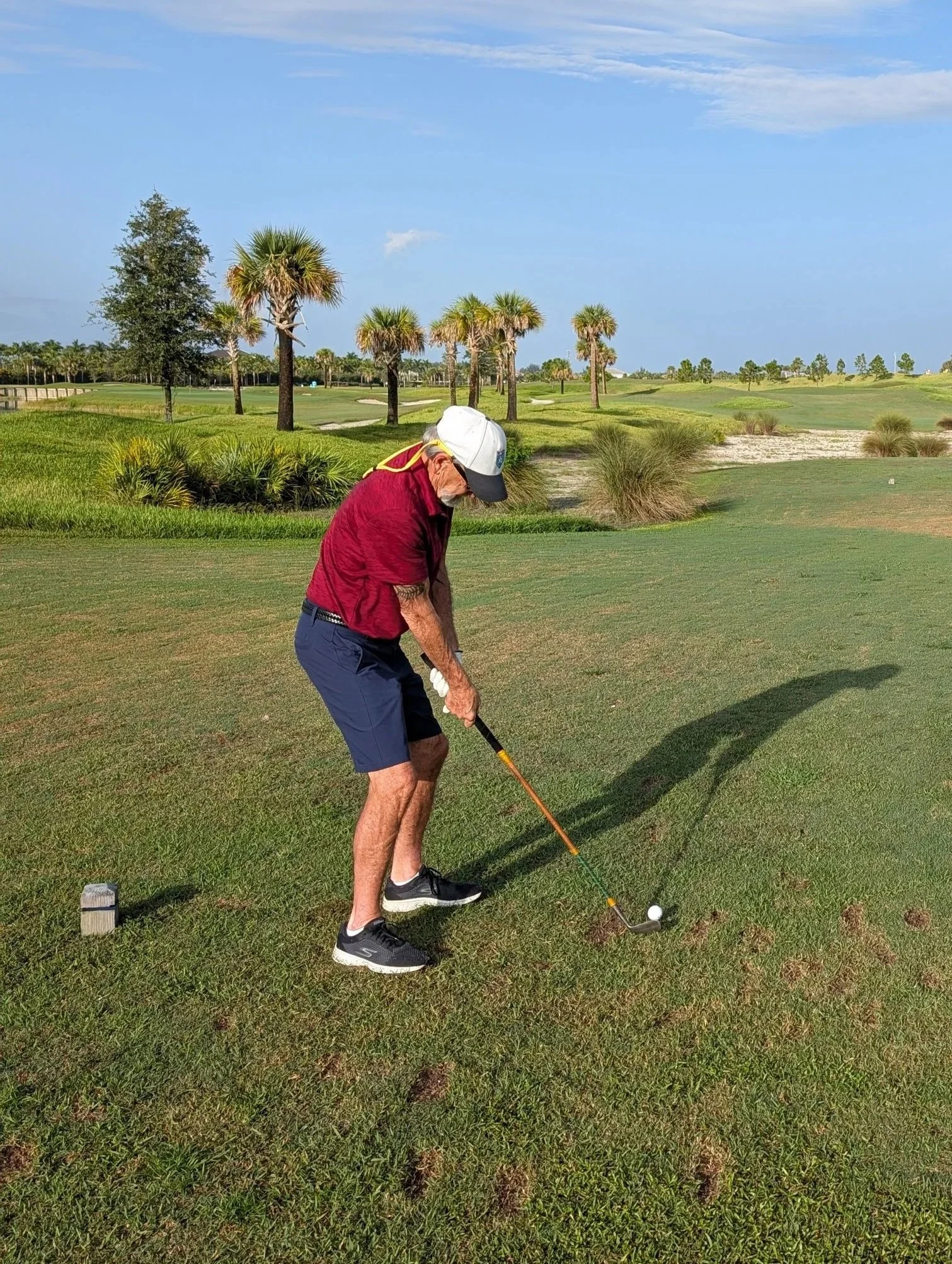 A golfer playing with a Groundhog Hickory Golf hickory golf club