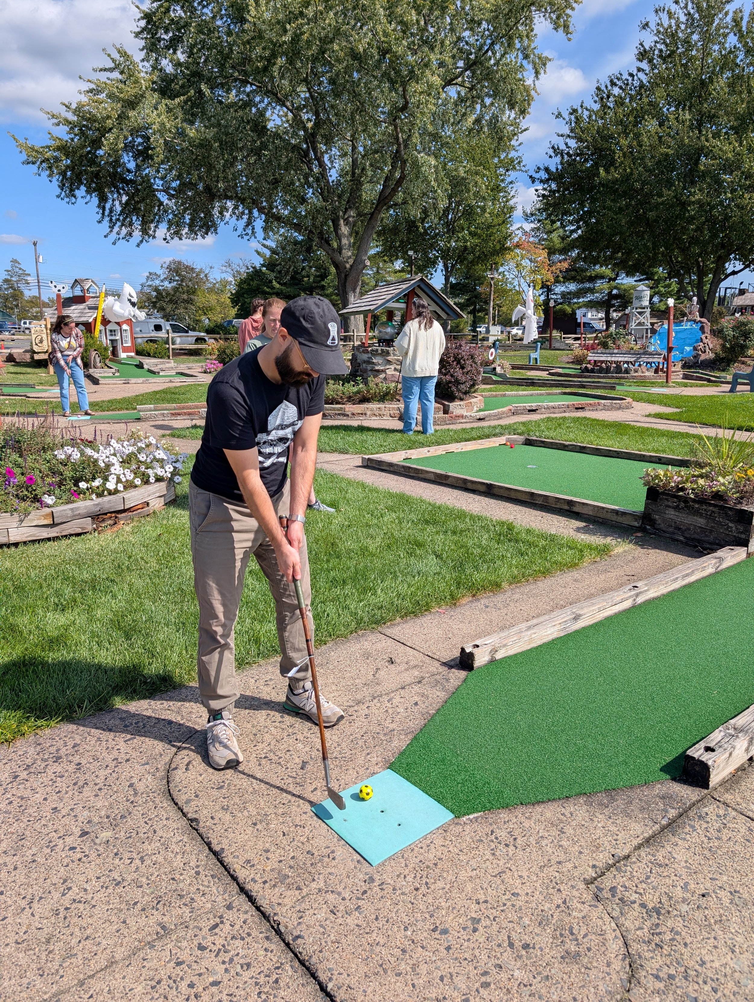 A golfer playing with a Groundhog Hickory Golf hickory golf club
