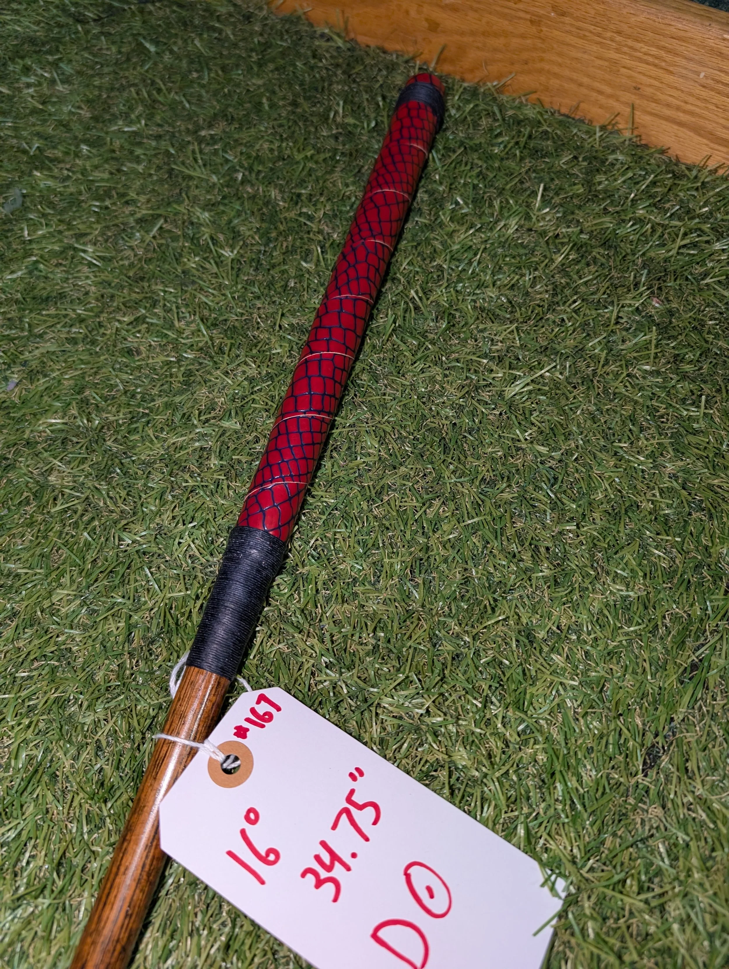 Hickory golf club putter with a red and blue alligator grip.