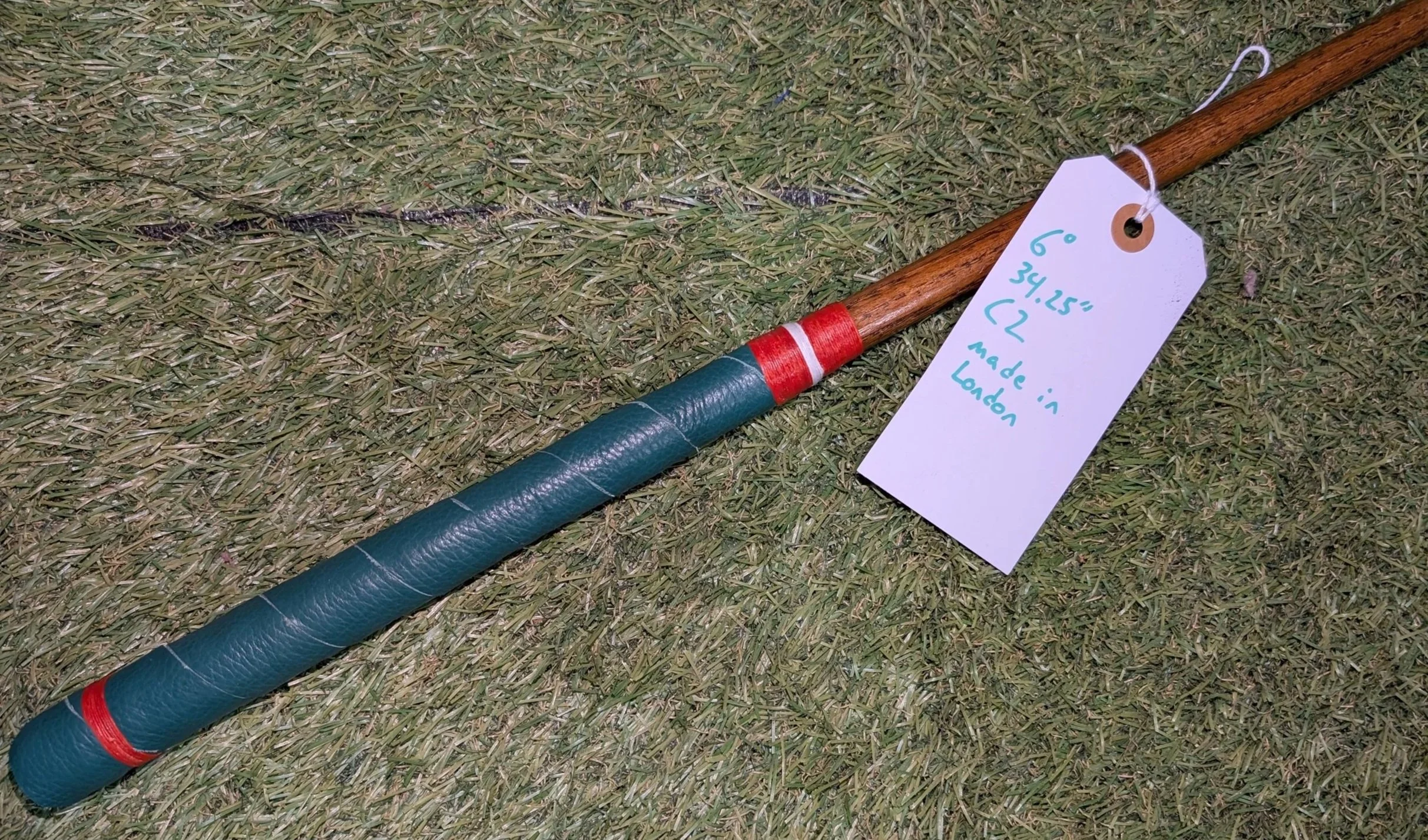 Ambidextrous hickory golf club putter with a brass head and Miami Hurricanes colors