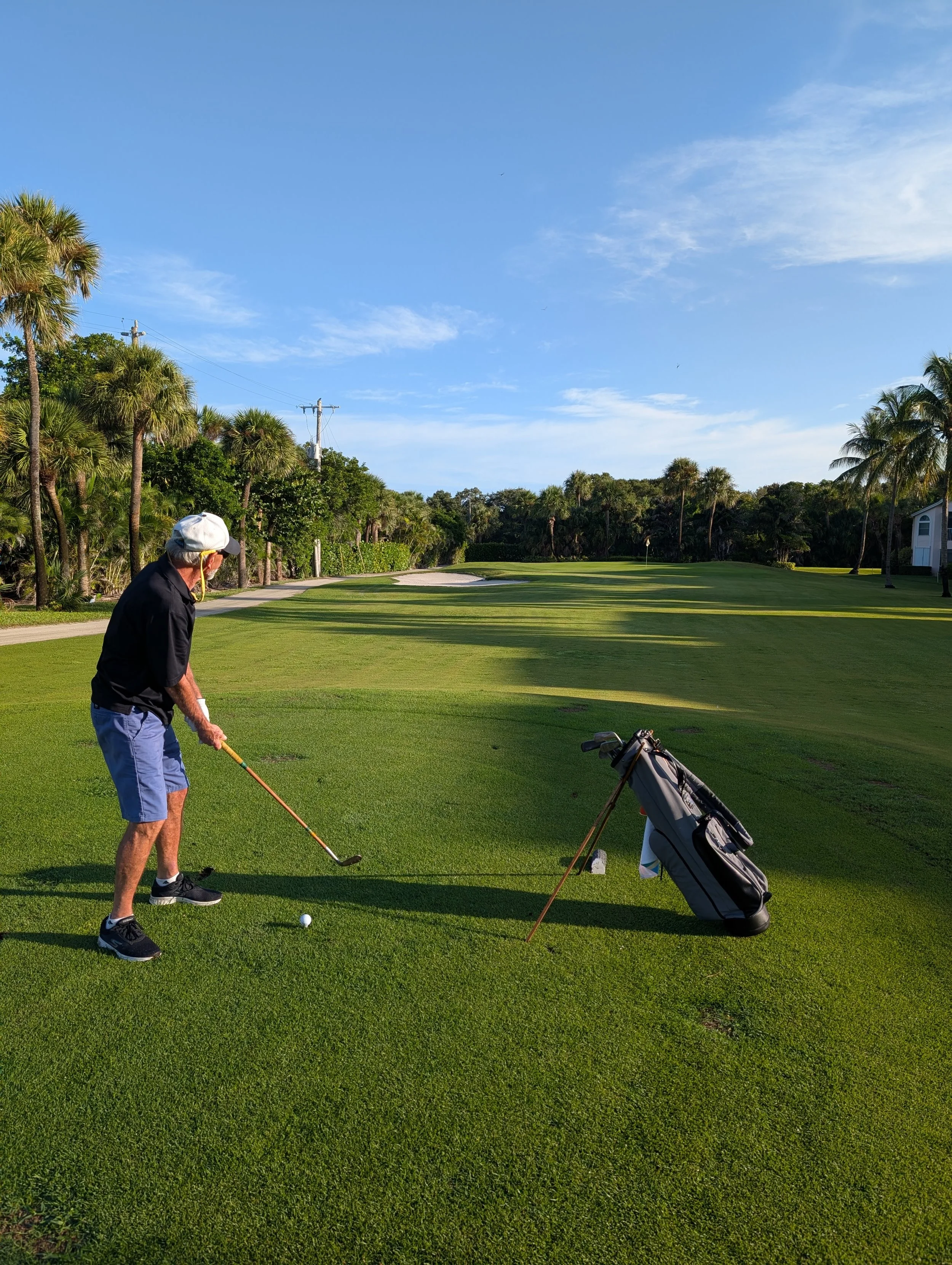 A golfer playing with a Groundhog Hickory Golf hickory golf club