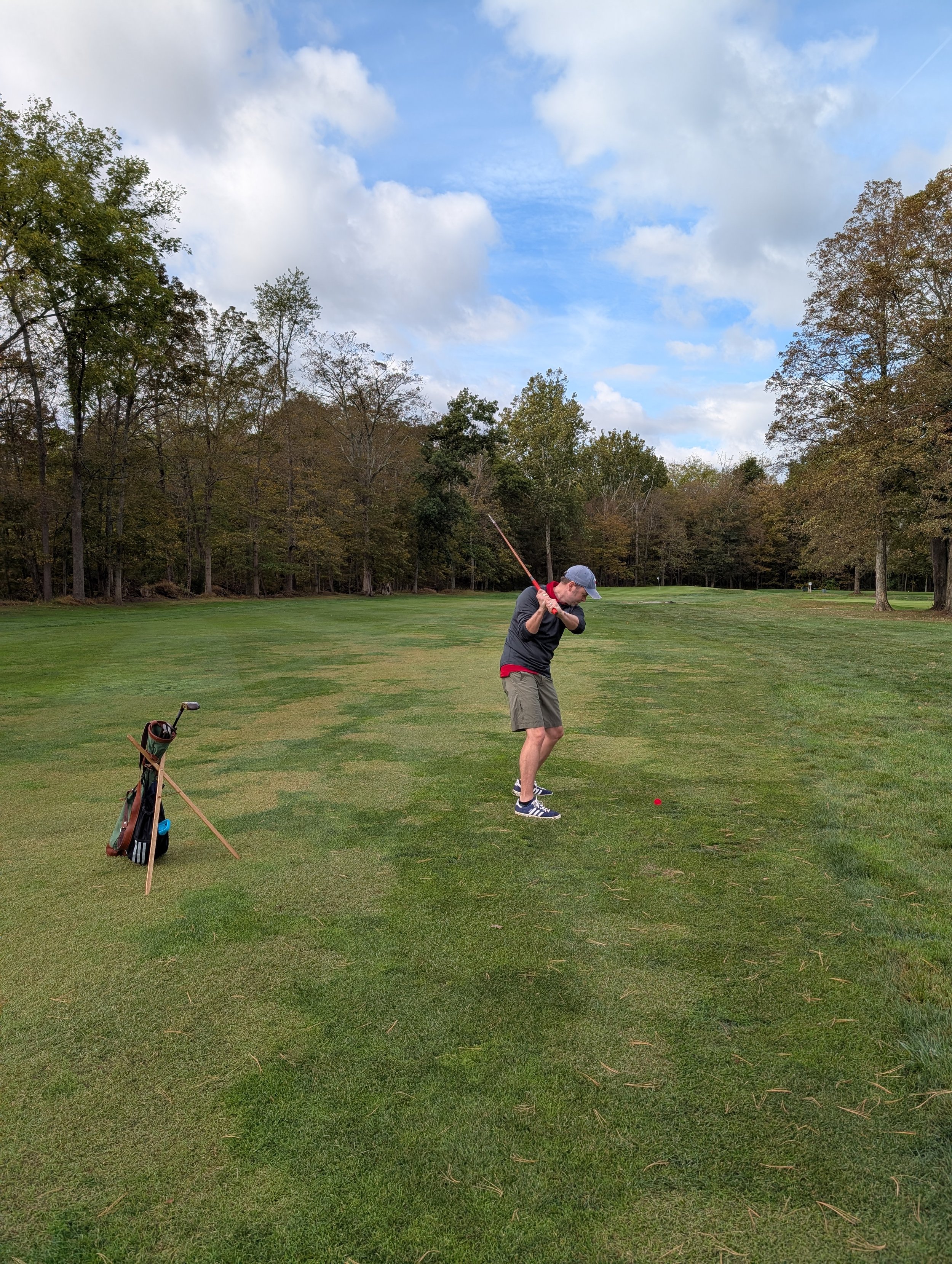 A golfer playing with a Groundhog Hickory Golf hickory golf club
