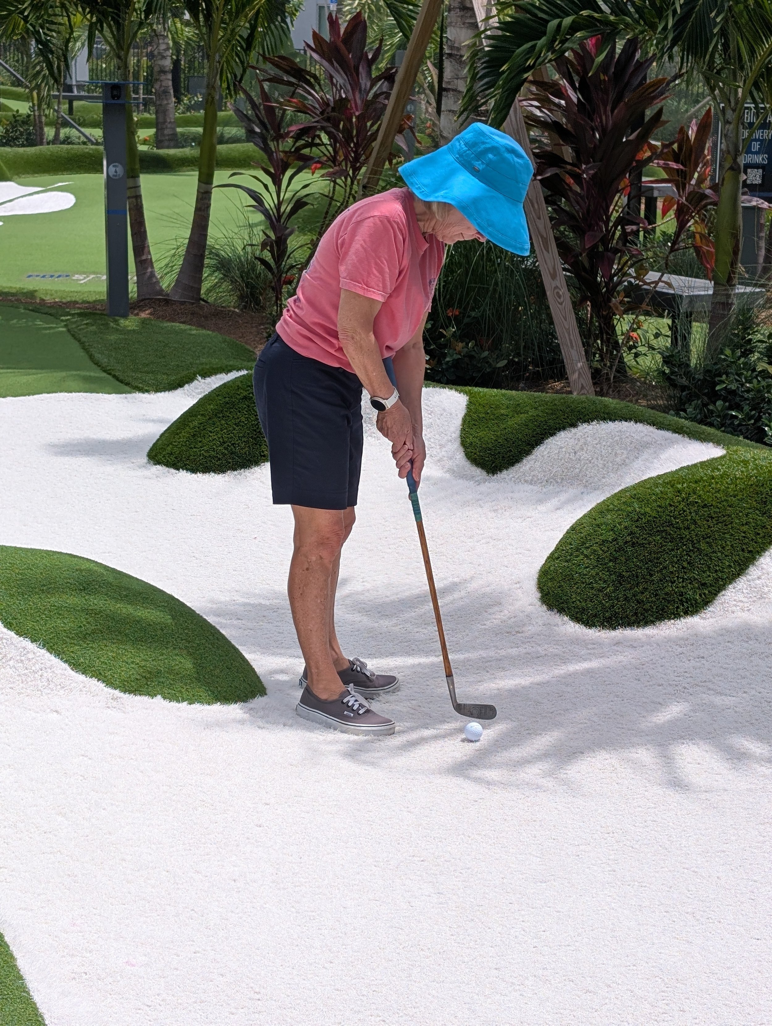 A golfer playing with a Groundhog Hickory Golf hickory golf club