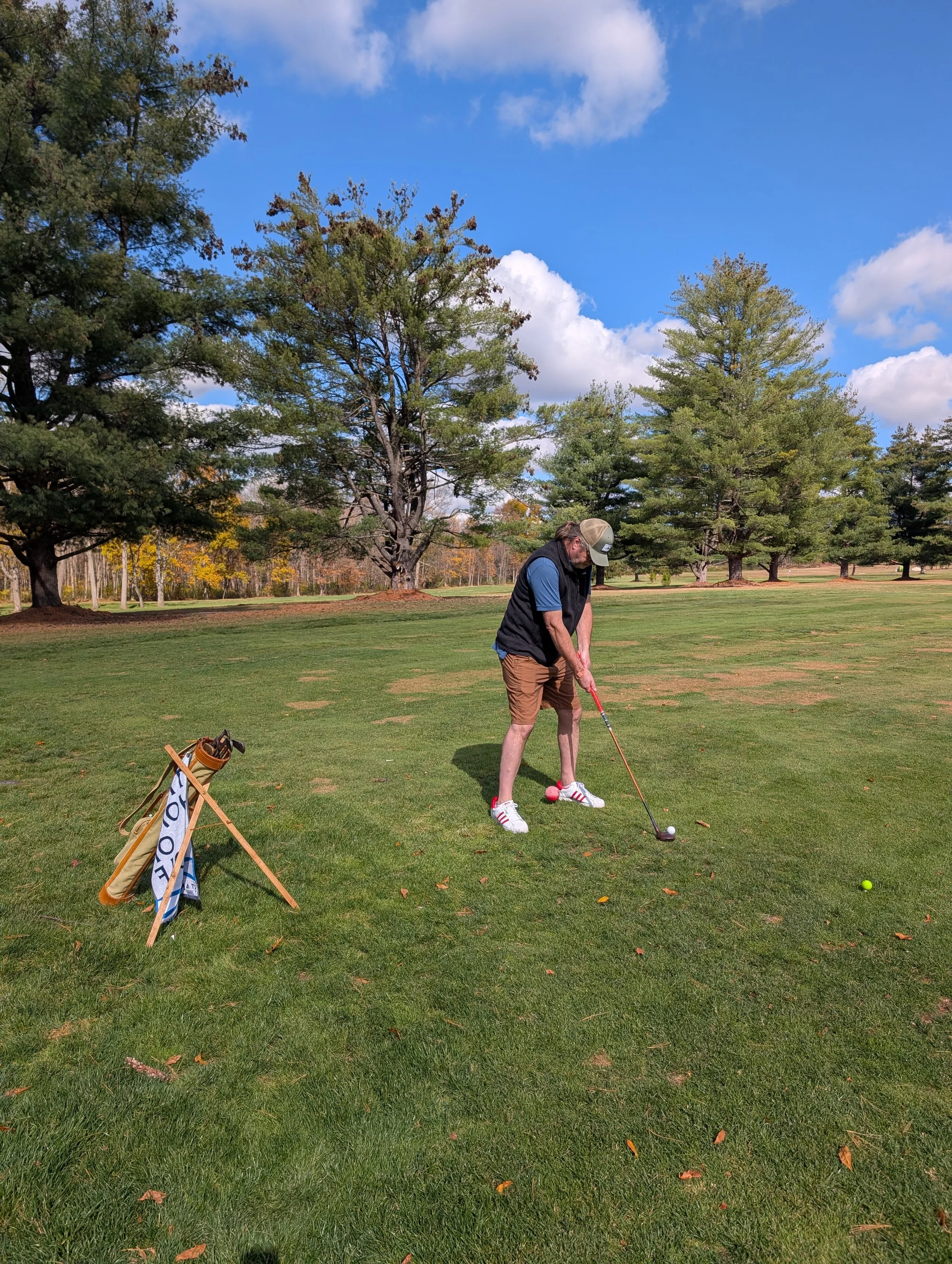 A golfer playing with a Groundhog Hickory Golf hickory golf club
