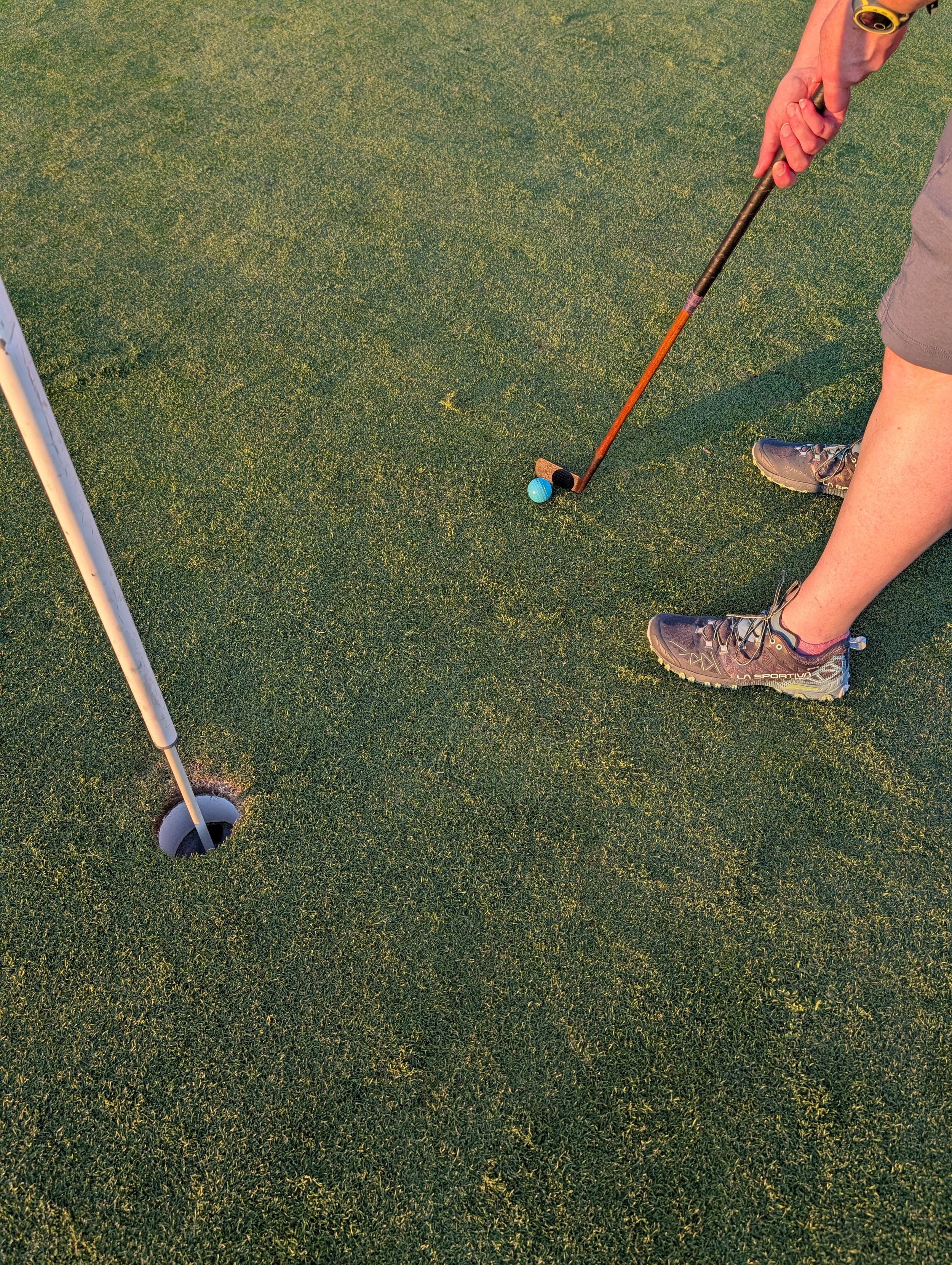 A golfer playing with a Groundhog Hickory Golf hickory golf club