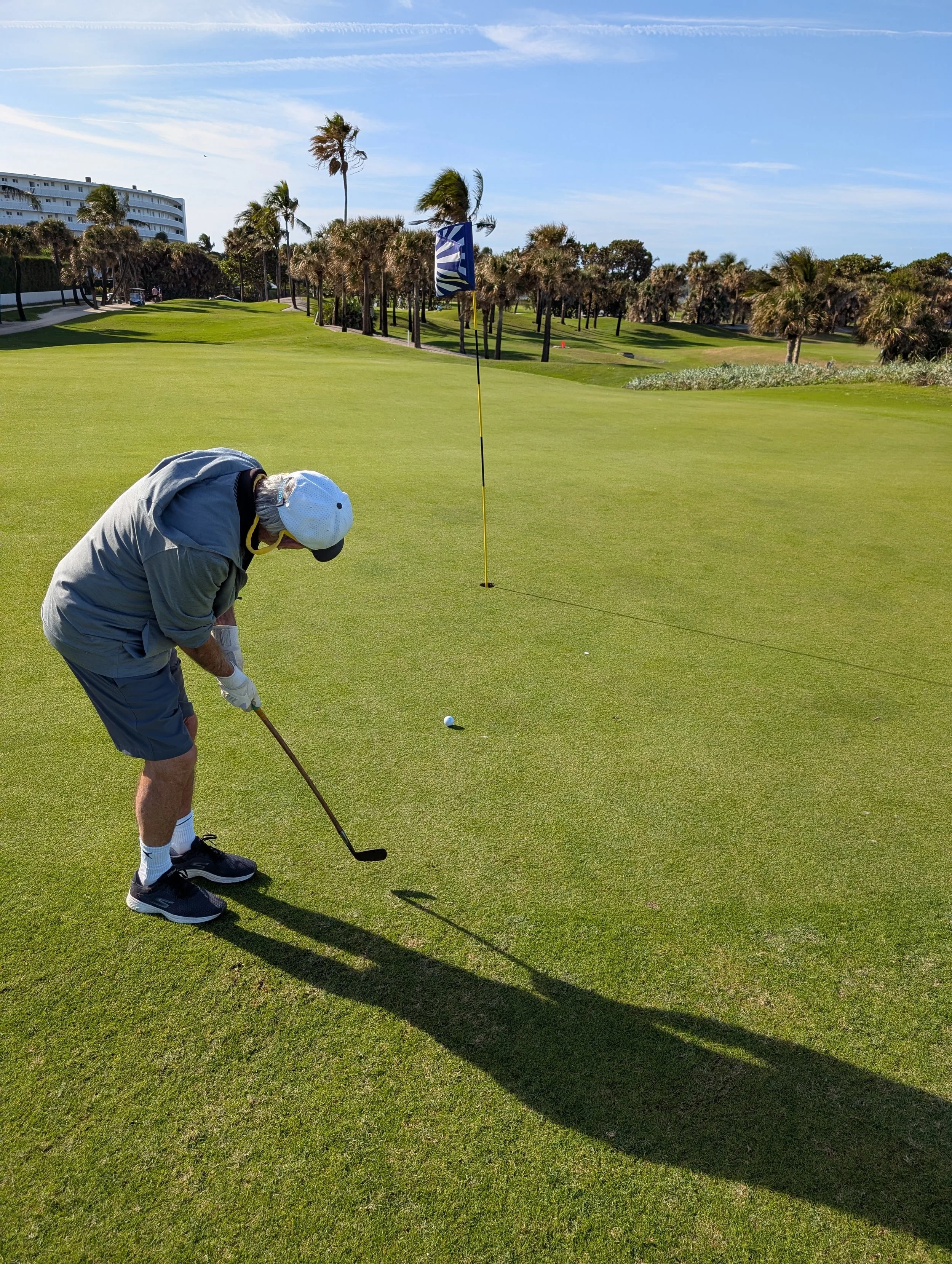 A golfer playing with a Groundhog Hickory Golf hickory golf club