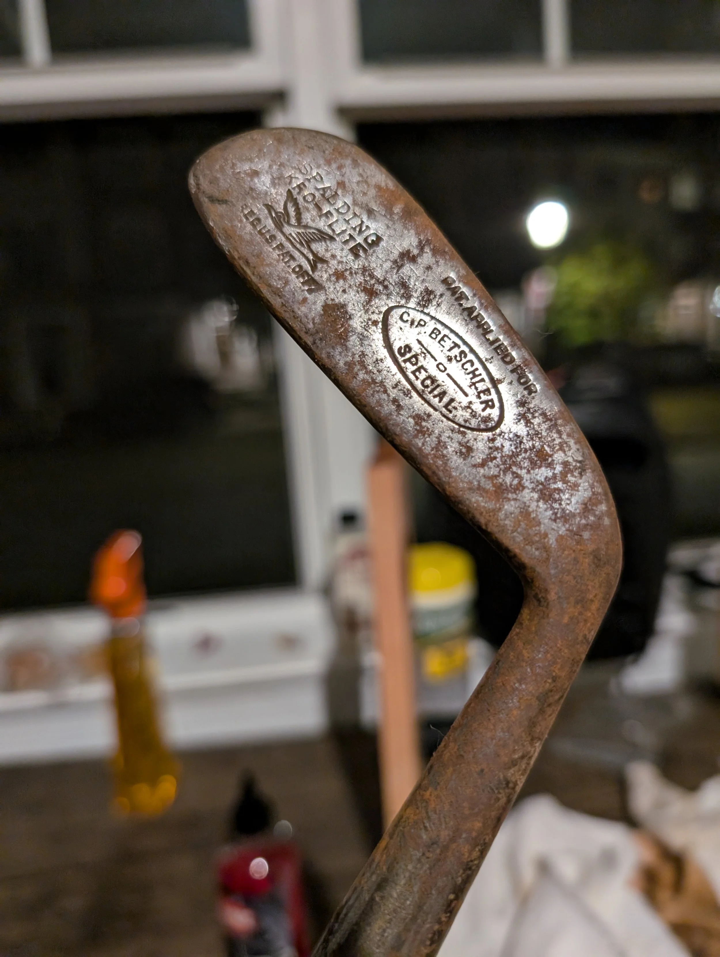 A rusty hickory golf club head before restoration.