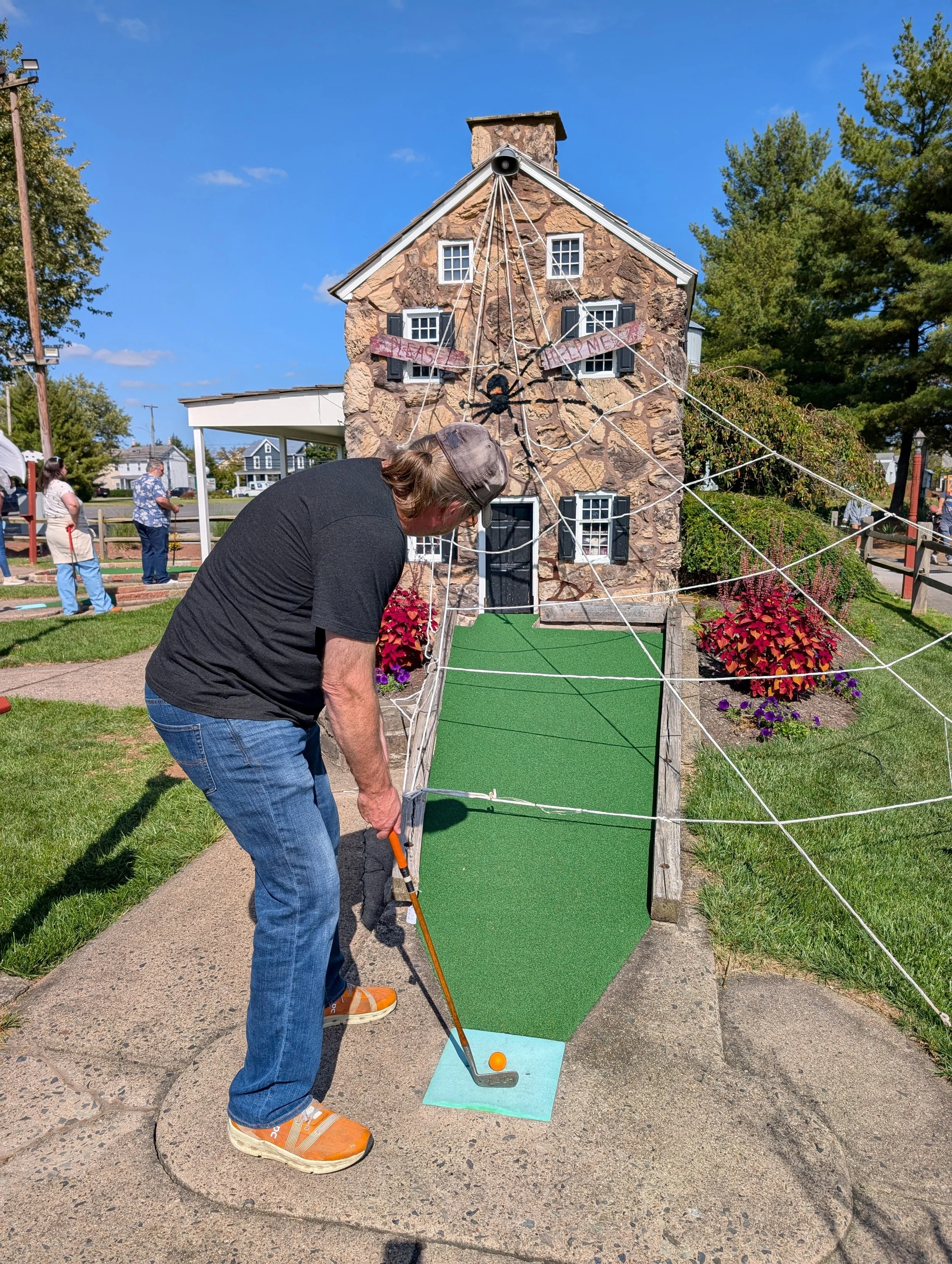A golfer playing with a Groundhog Hickory Golf hickory golf club