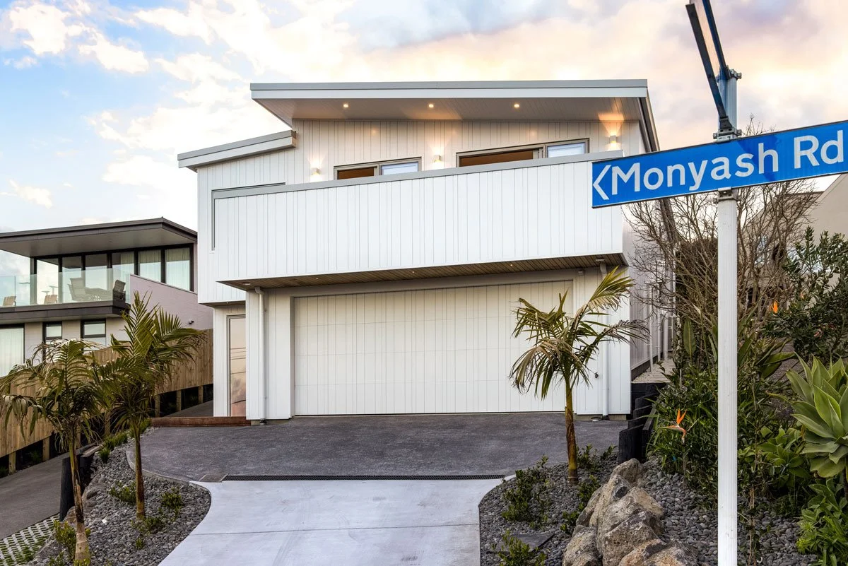Modern home exterior with double garage and landscaping, Bay View new build by Ze Build