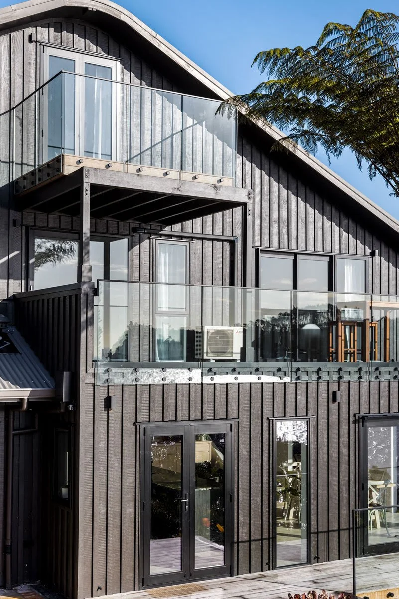 External shot of cladded gable and modernised deck railing — a sleek coastal renovation by Ze Build