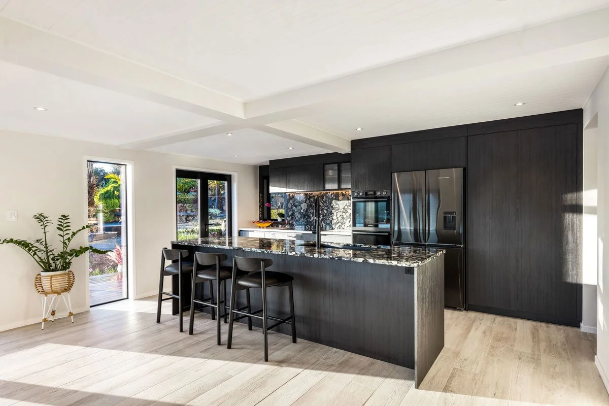 Kitchen and dining extension filled with natural light and coastal views, part of full renovation