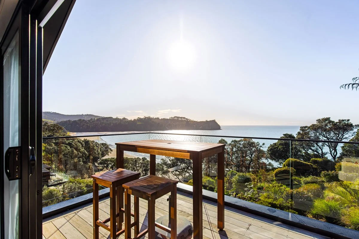Elevated outdoor entertaining space on timber deck with direct beach views