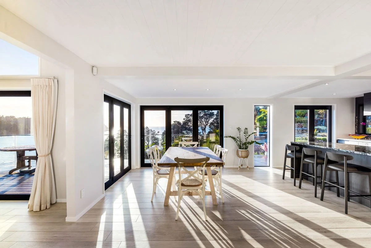 Renovated dining zone with natural light, crisp detailing and seamless flow to outdoor entertaining space.