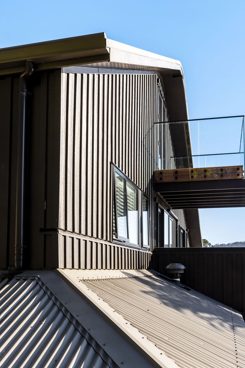 Renovated Juliet balcony with glass railing overlooking modern Kanda deck layers at Hatfields Beach.