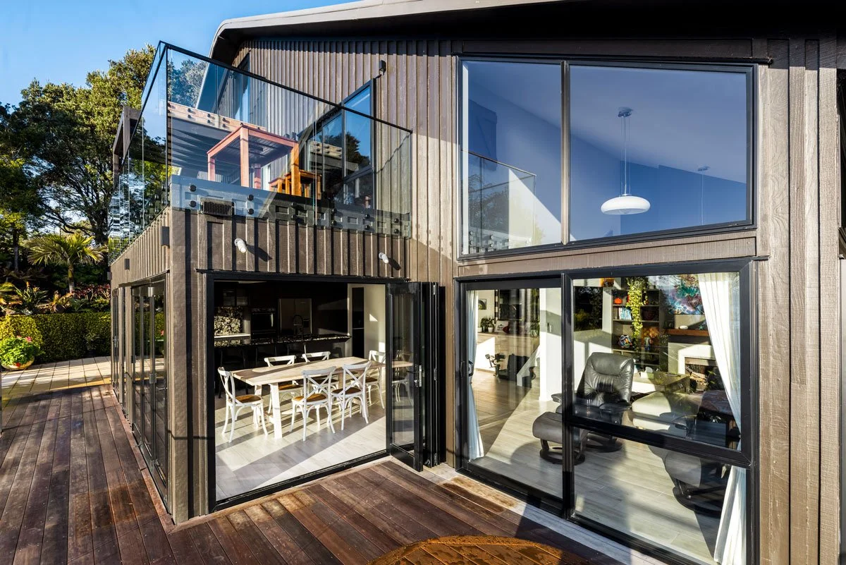 Board and batten detailing and glass balcony installed on renovated Auckland home exterior
