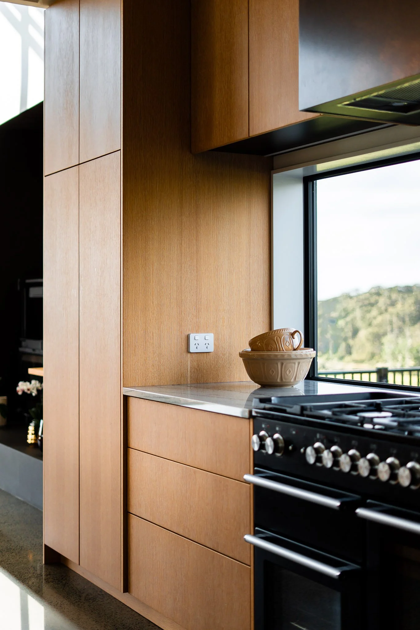 Soft lighting inside the hallway accentuates materiality and spatial flow.